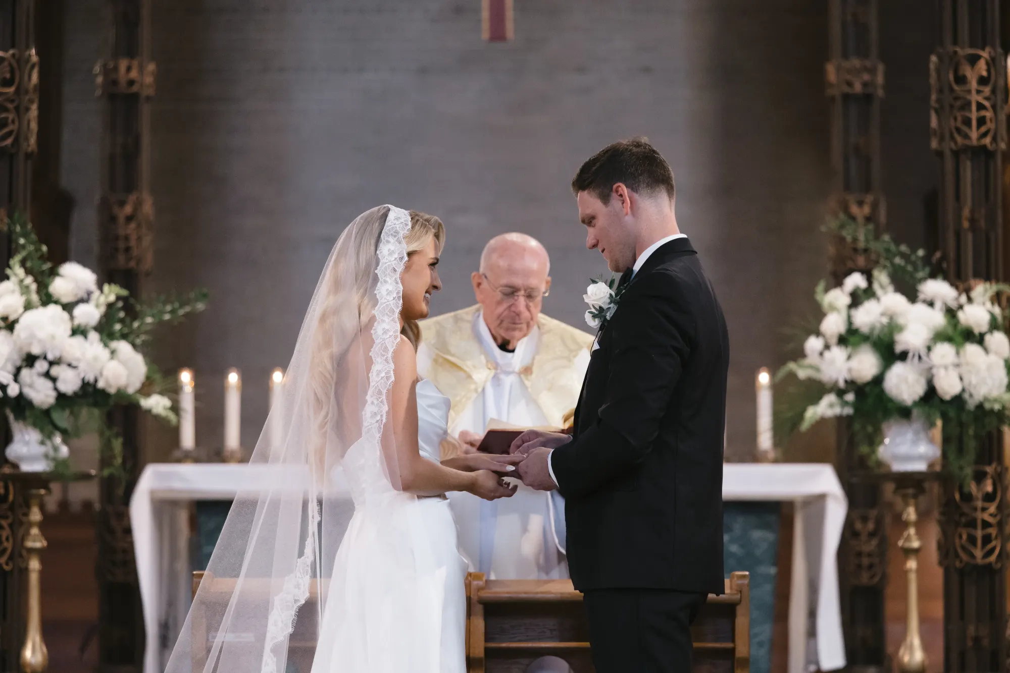 Father Bernard reads the blessing between the couple