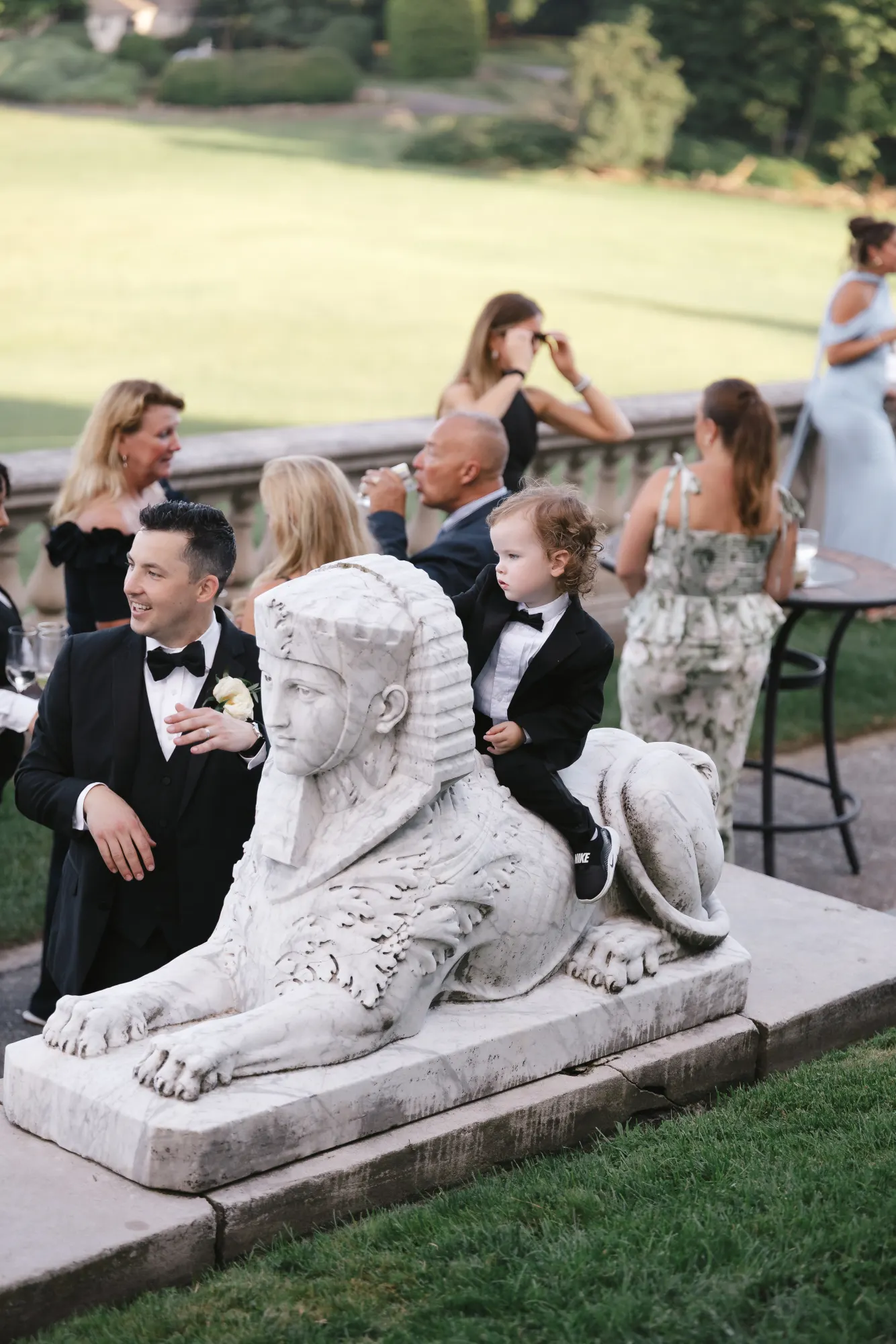 Cocktail hour around the stone sphinx on the terrace