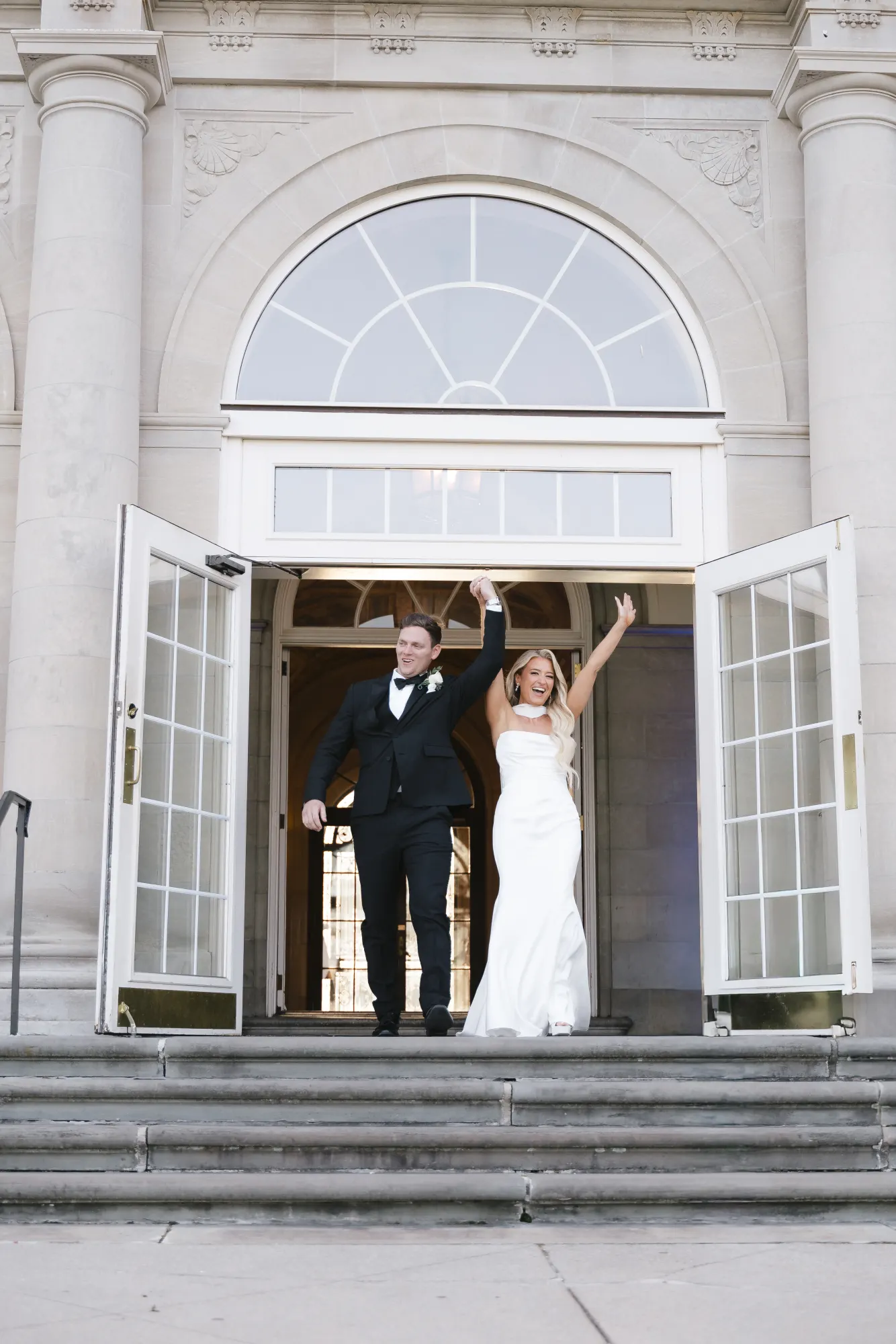 The newlyweds burst through the terrace doors to cheers