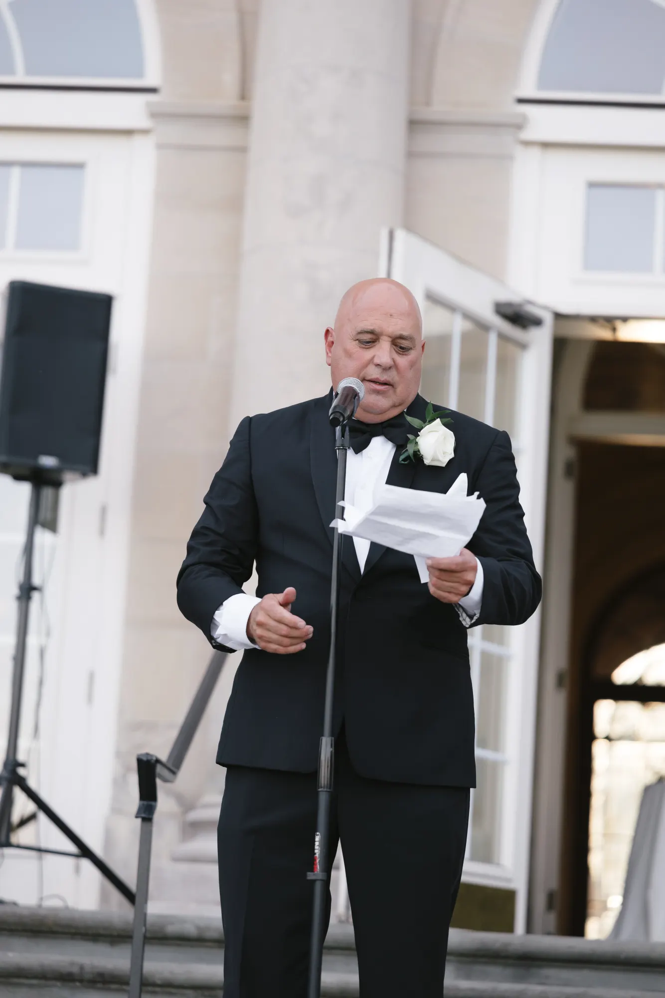 The father of the bride delivers his toast on the terrace