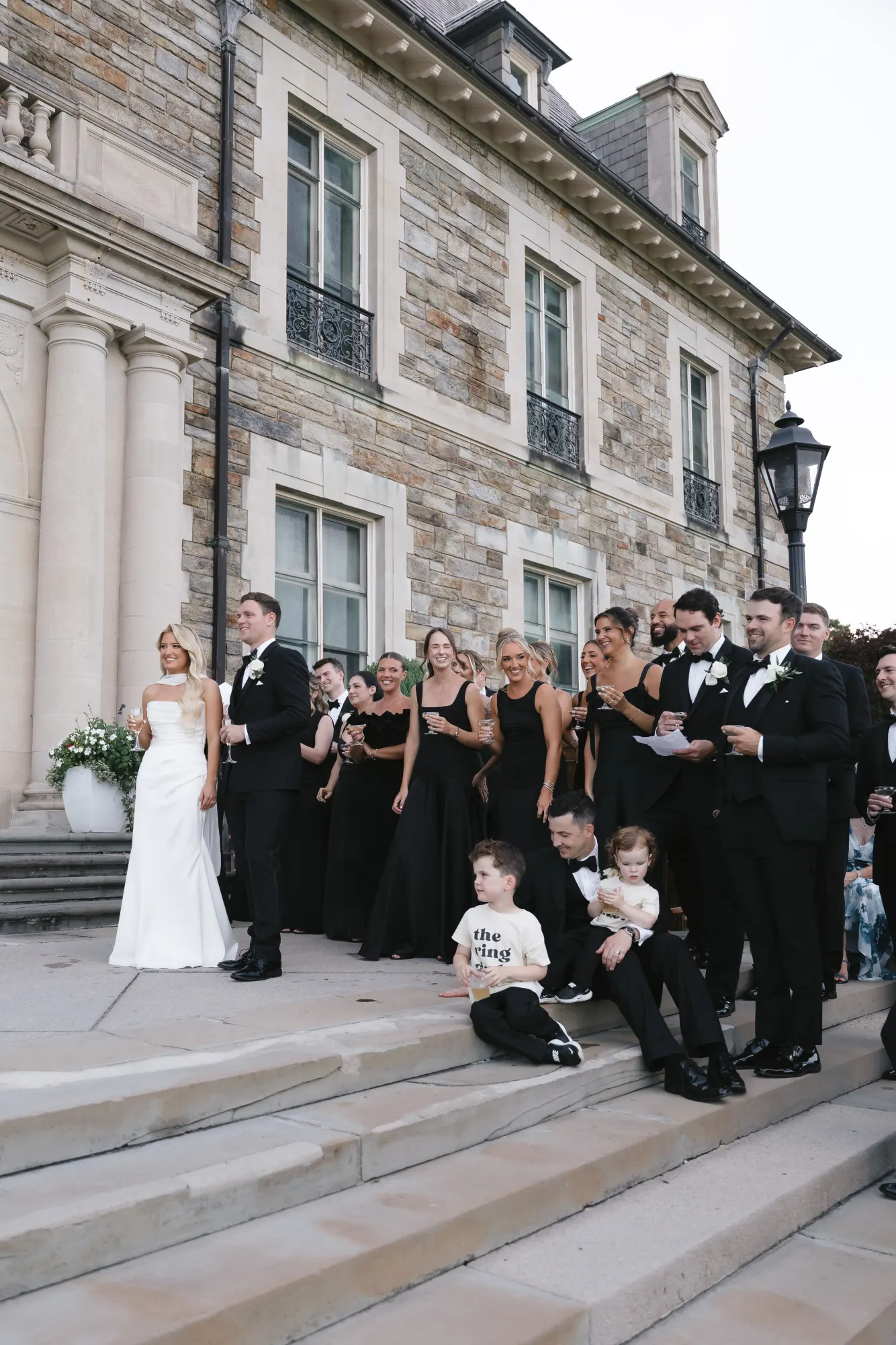 The couple and wedding party gathered on the steps for speeches