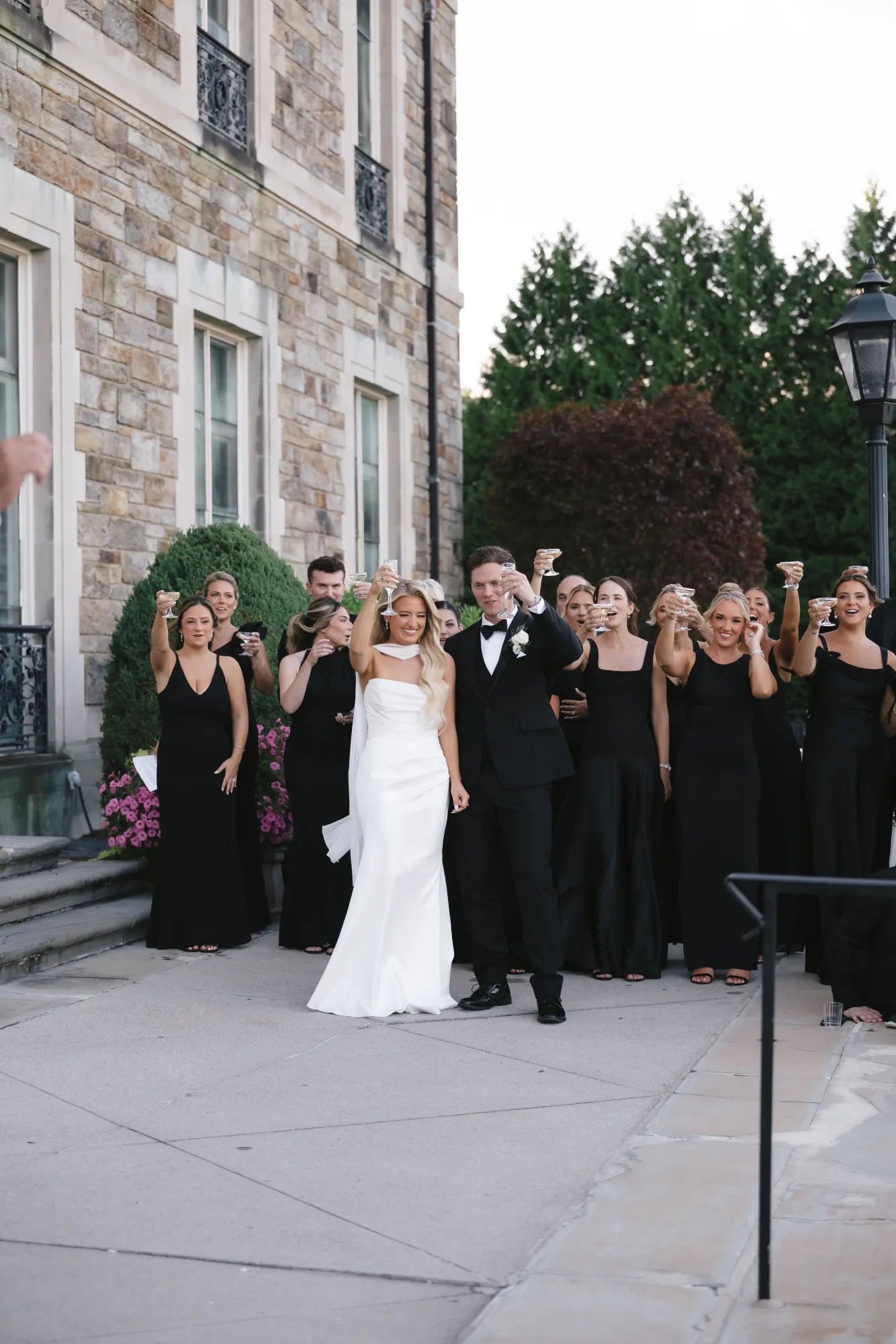 The couple laughs through the speeches with the bridesmaids