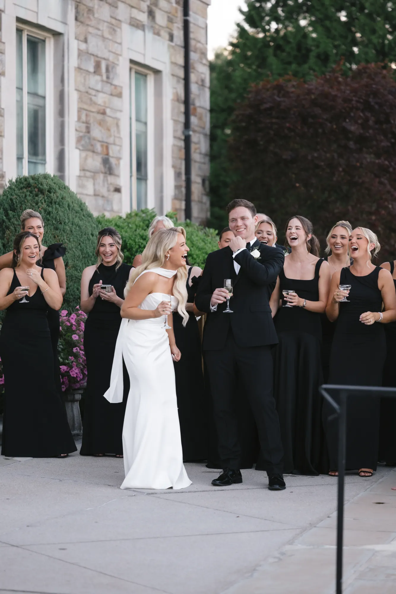 Laughter ripples through the wedding party during a toast