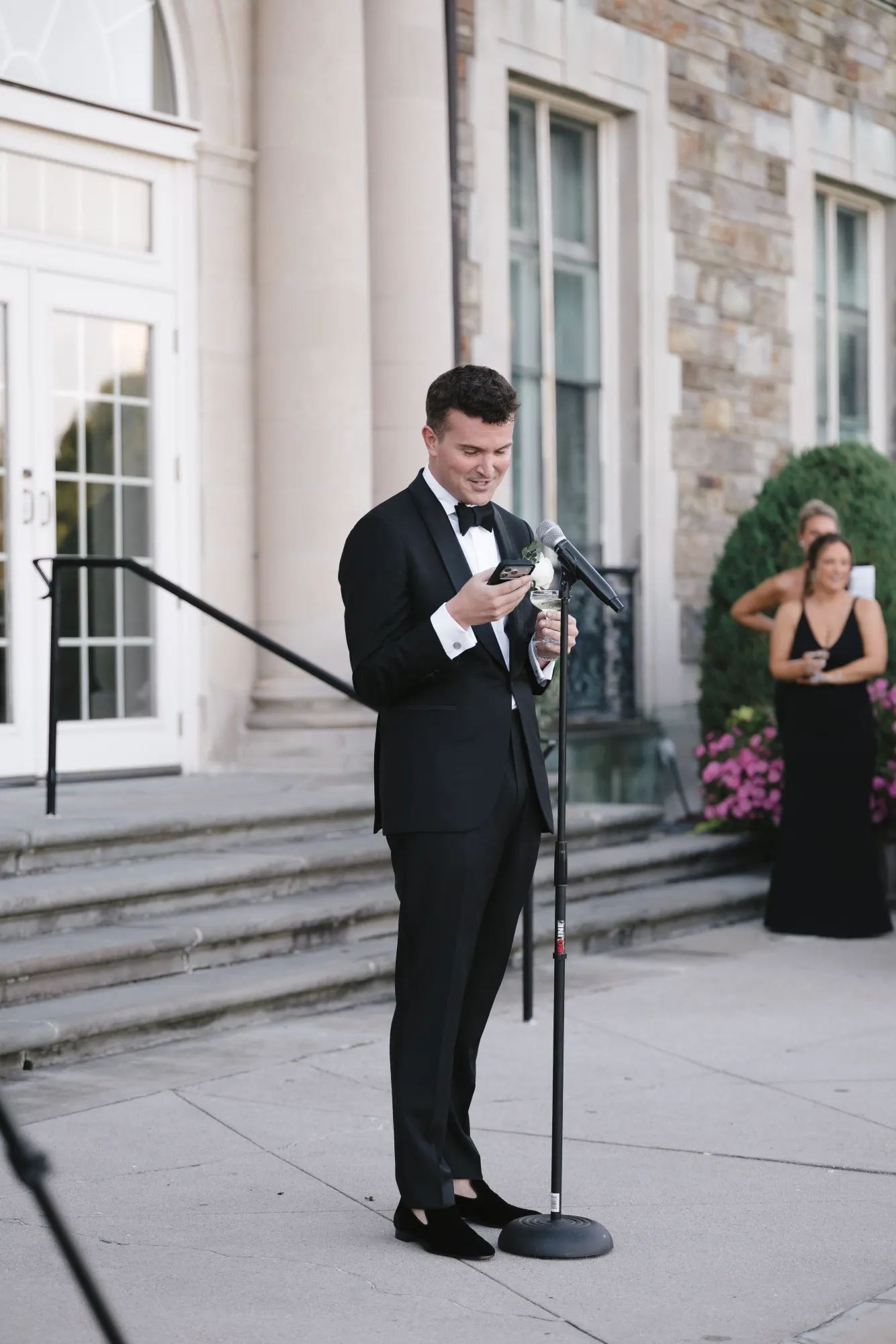 The best man raises his toast at the microphone