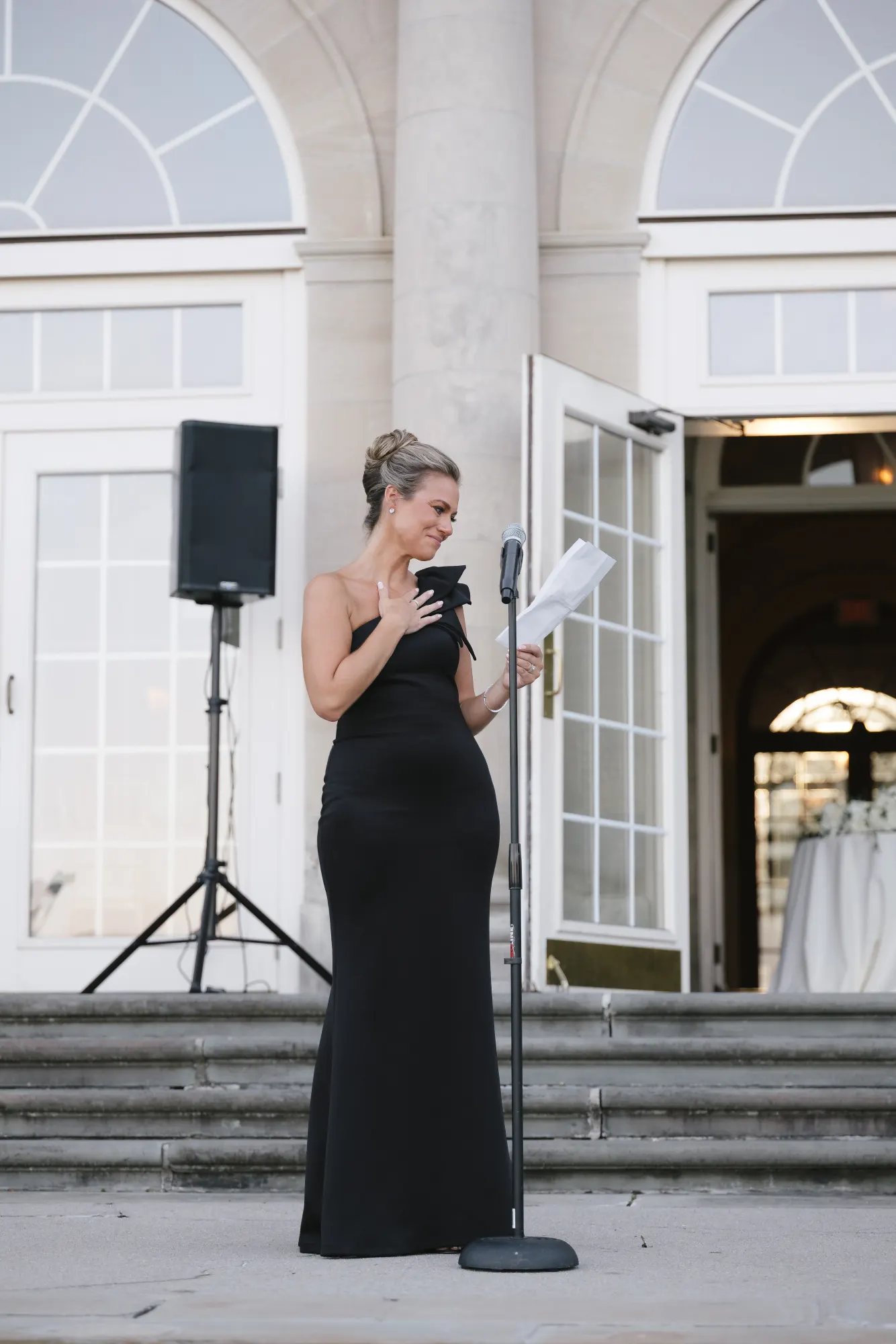 The maid of honor delivers her toast on the terrace steps