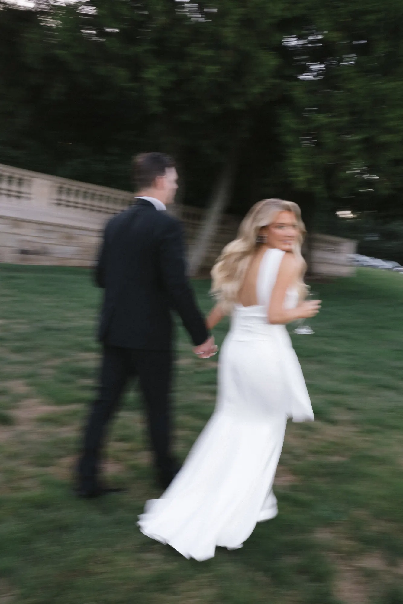 Hand in hand across the lawn as the light fades