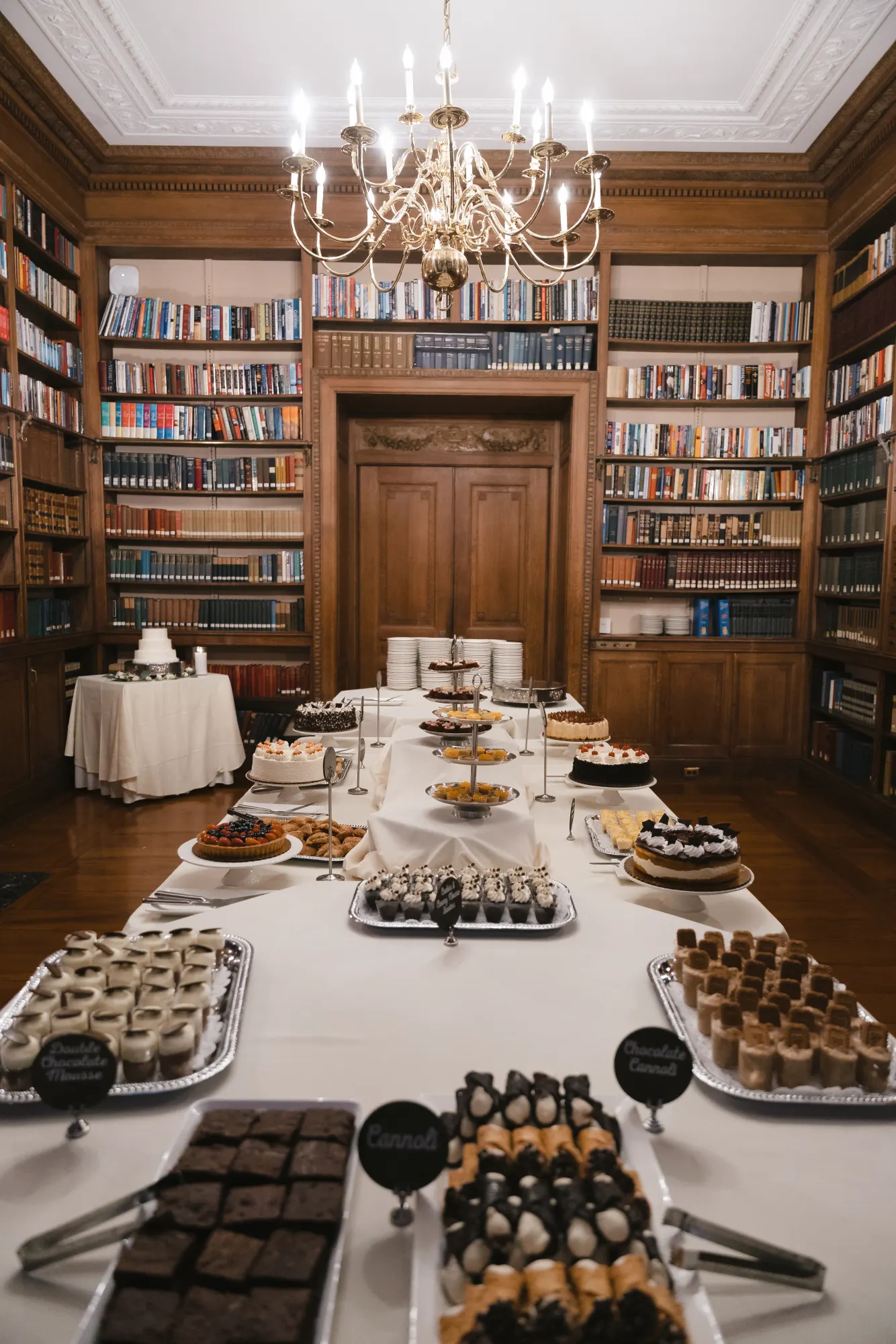 The dessert room table beneath the library chandelier