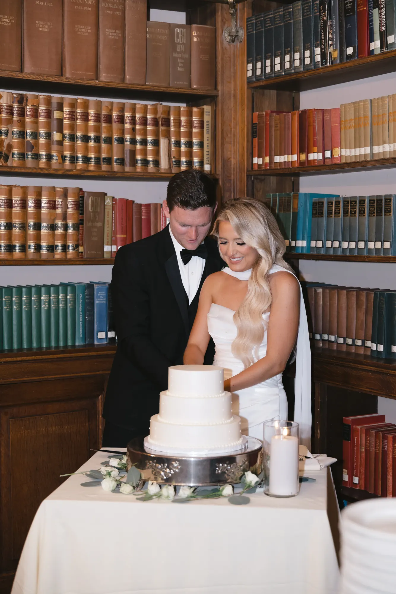 Colleen and Max cut the cake in the library