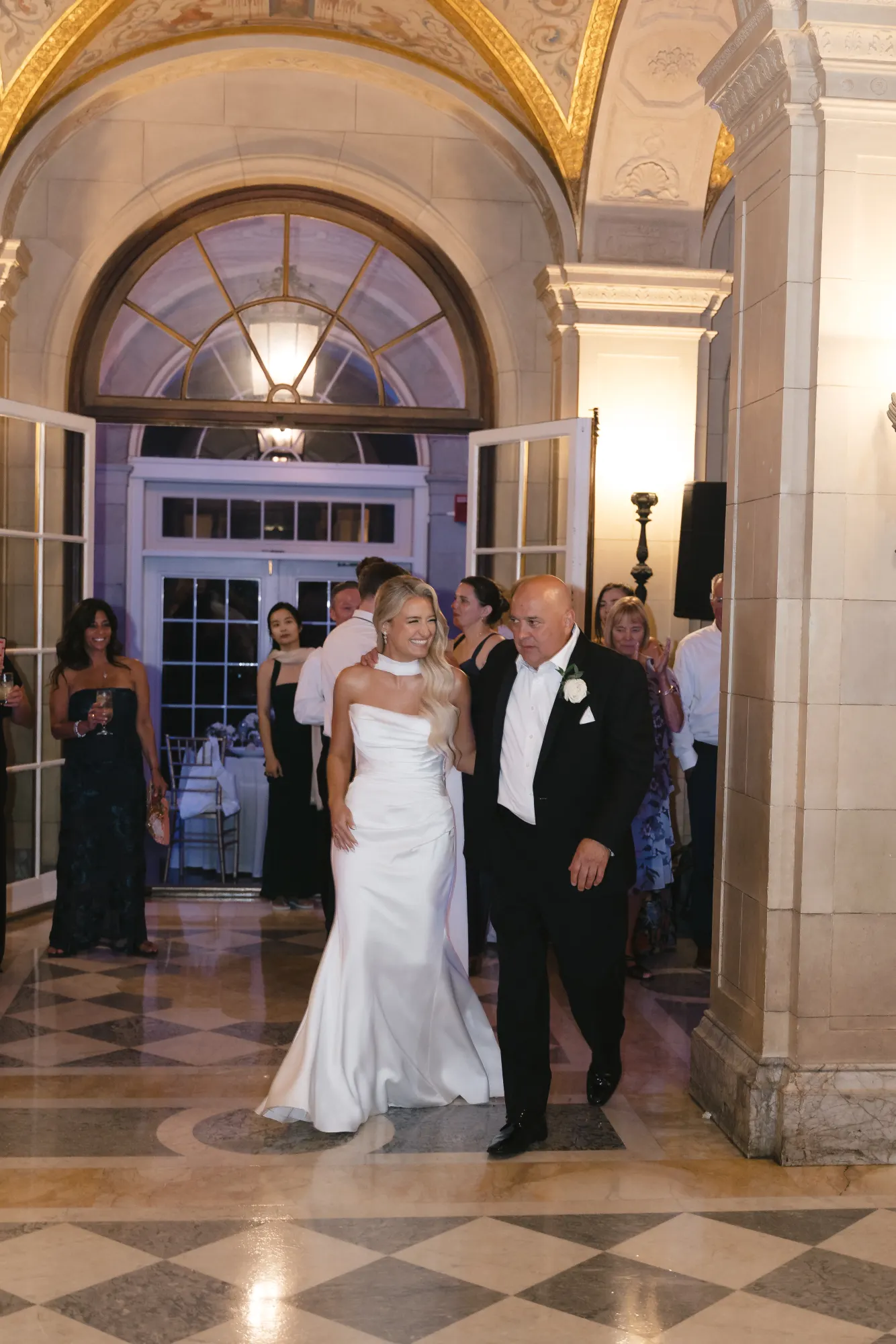 Colleen and her father head to the dance floor beneath the arches