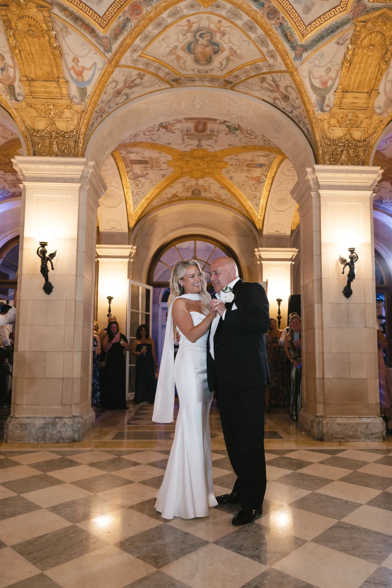 The father-daughter dance in the frescoed great hall