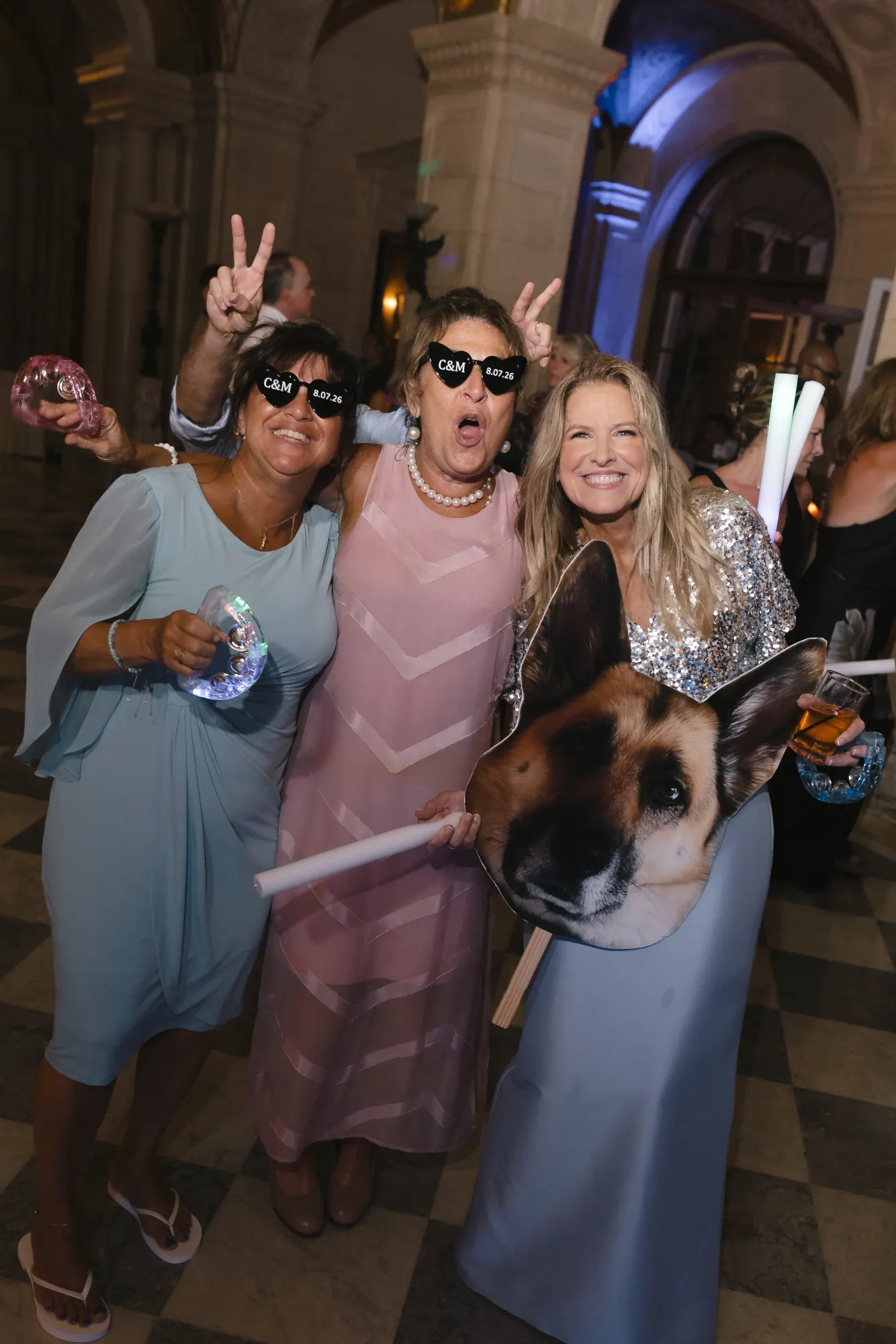 Guests mug for the camera with the dog cutout on the dance floor
