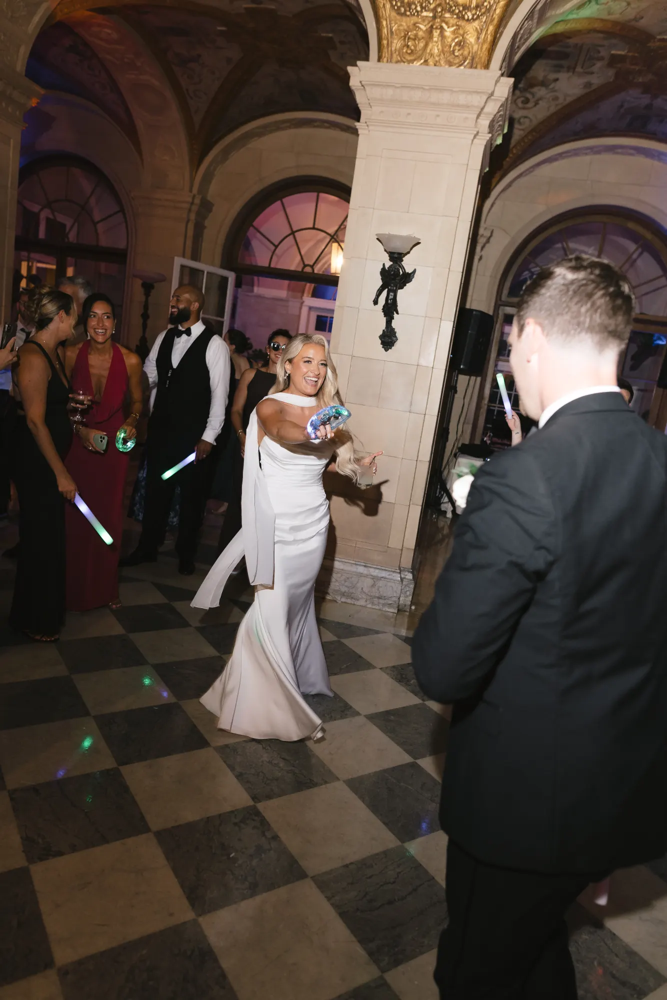 Colleen laughing under the DJ lights as the night rolls on