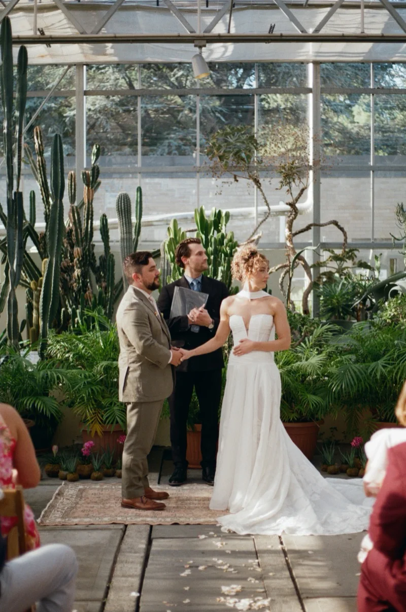 Ring exchange during Gabi and Ike ceremony at Roger Williams Botanical Center