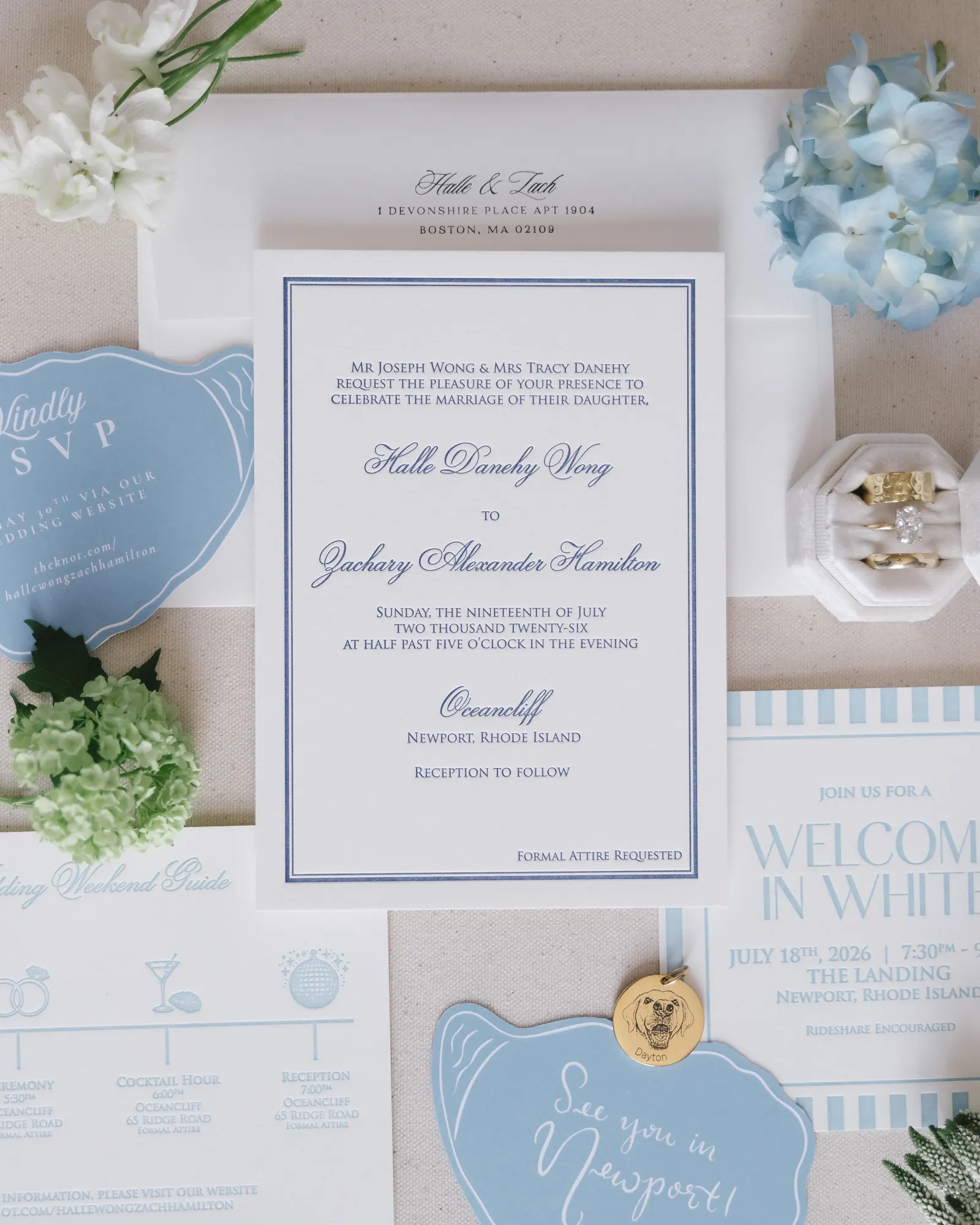 Blue-and-white wedding invitation suite with hydrangea, rings, and a welcome timeline for the Newport weekend