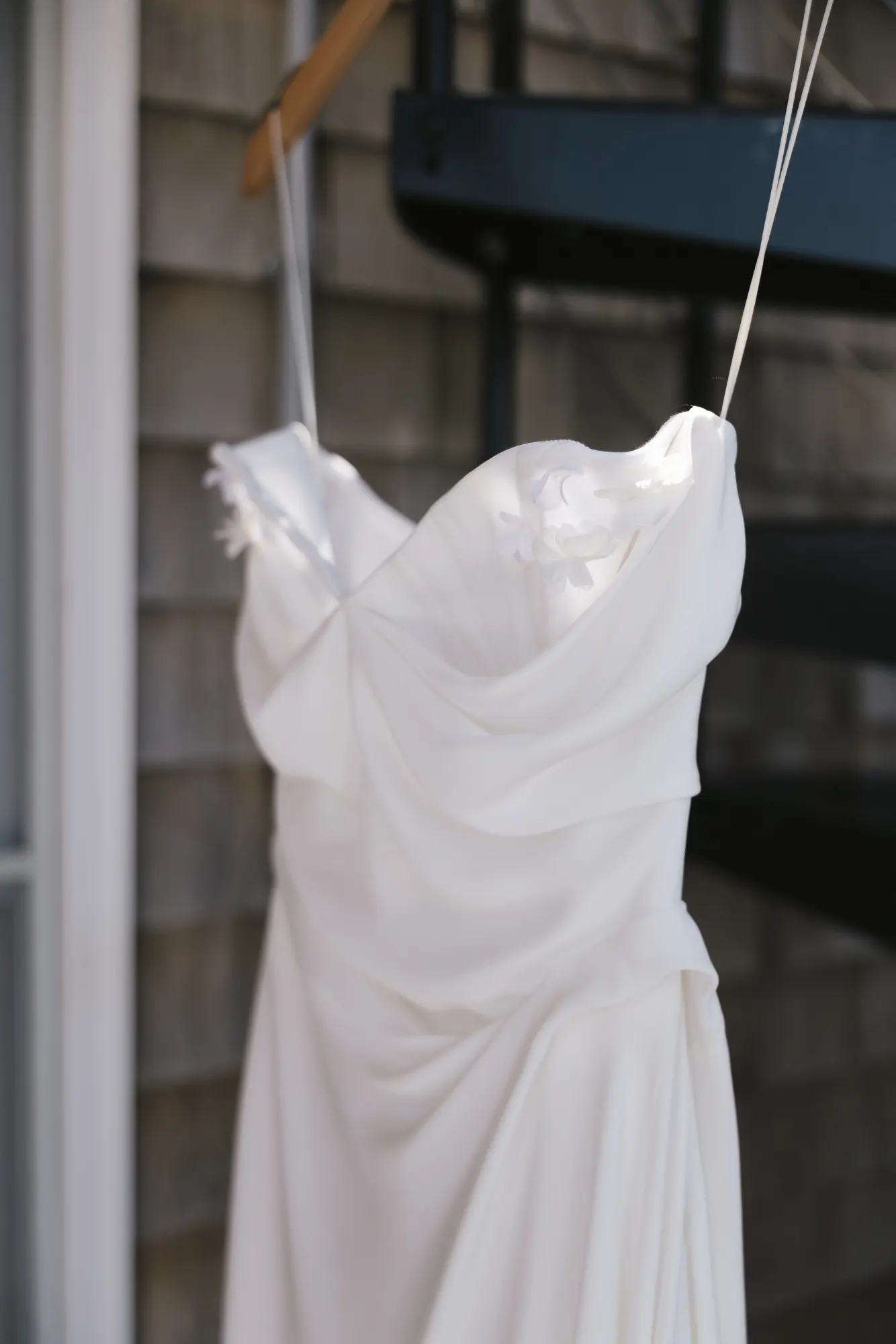 Detail of the draped bodice of the bride's gown in the morning light