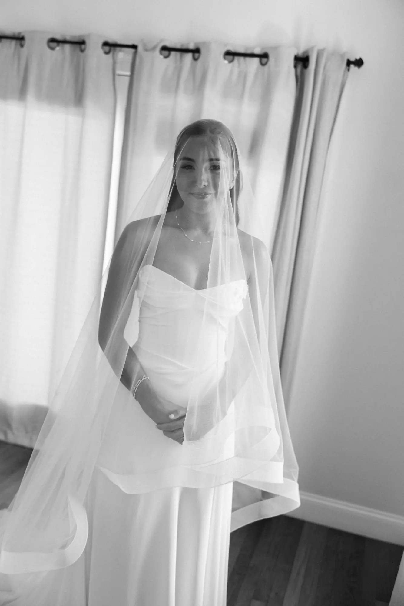 Black and white portrait of the bride beneath her veil