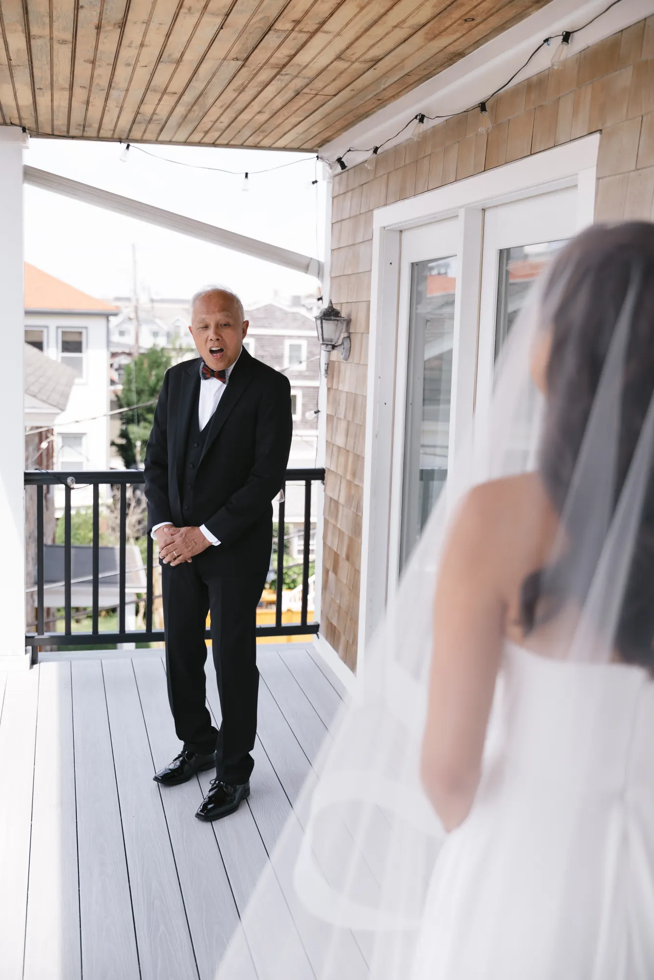 First look with the bride's father on the porch of the Newport cottage
