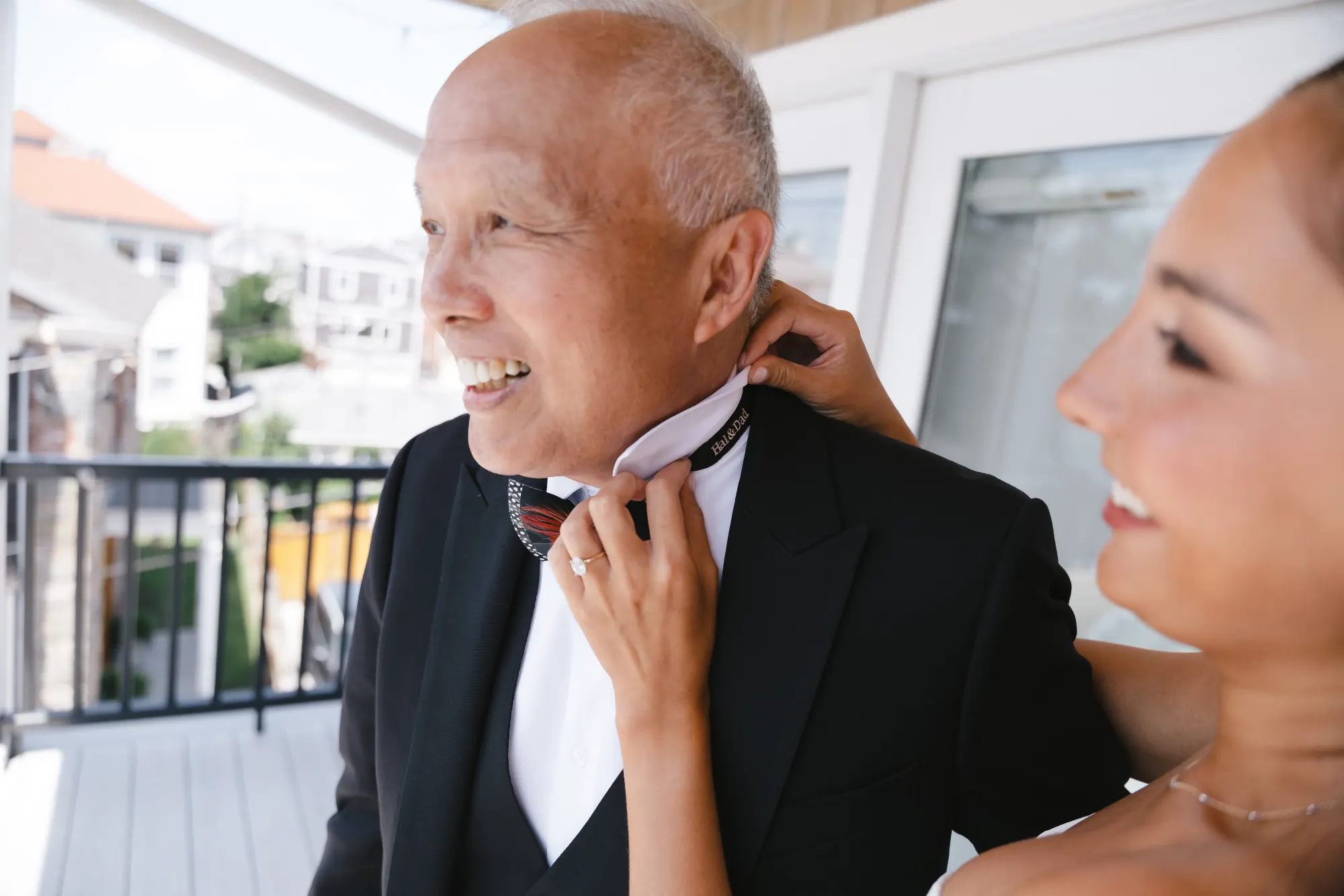 Bride straightens her father's bow tie before the ceremony