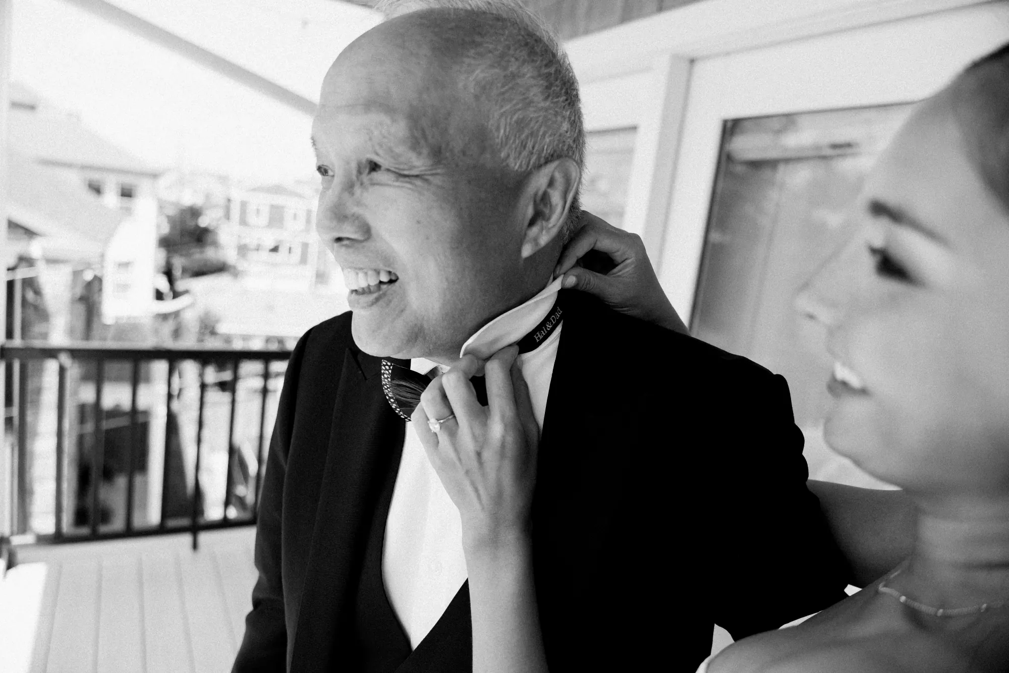 Black and white moment between the bride and her father on the porch