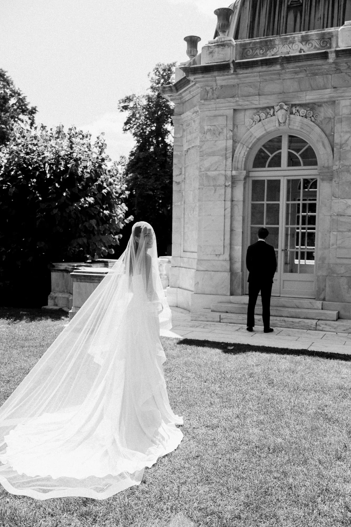 Black and white of the bride approaching her groom at The Elms