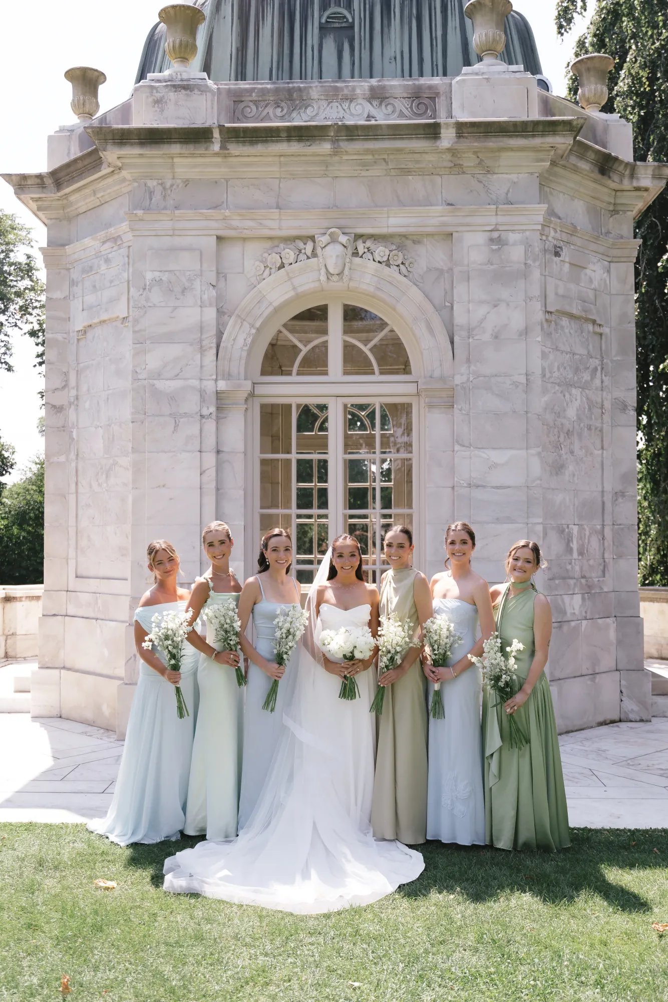 Bride with her bridesmaids in mixed pastel gowns at The Elms