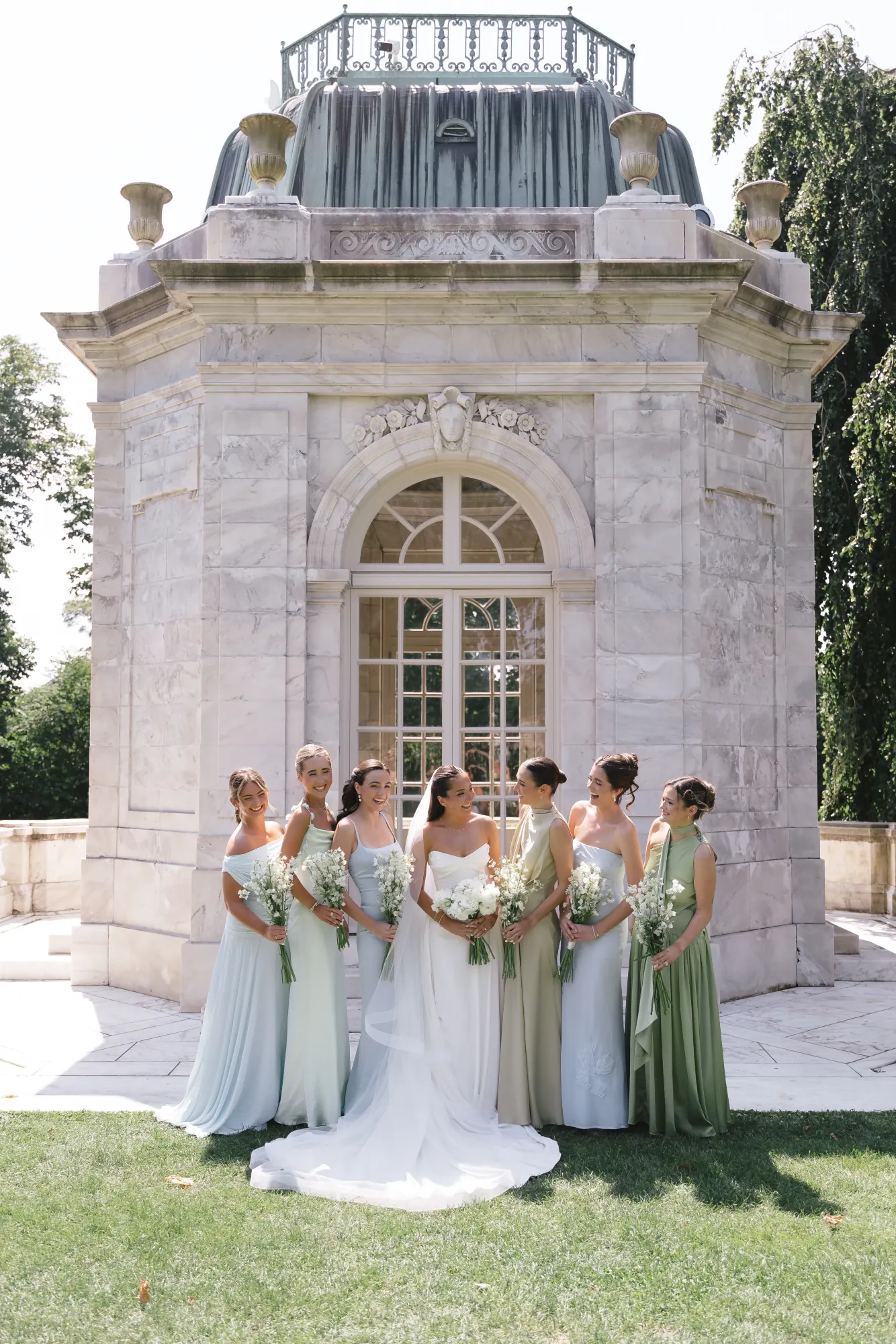 Bridesmaids gathered around the bride at The Elms gardens