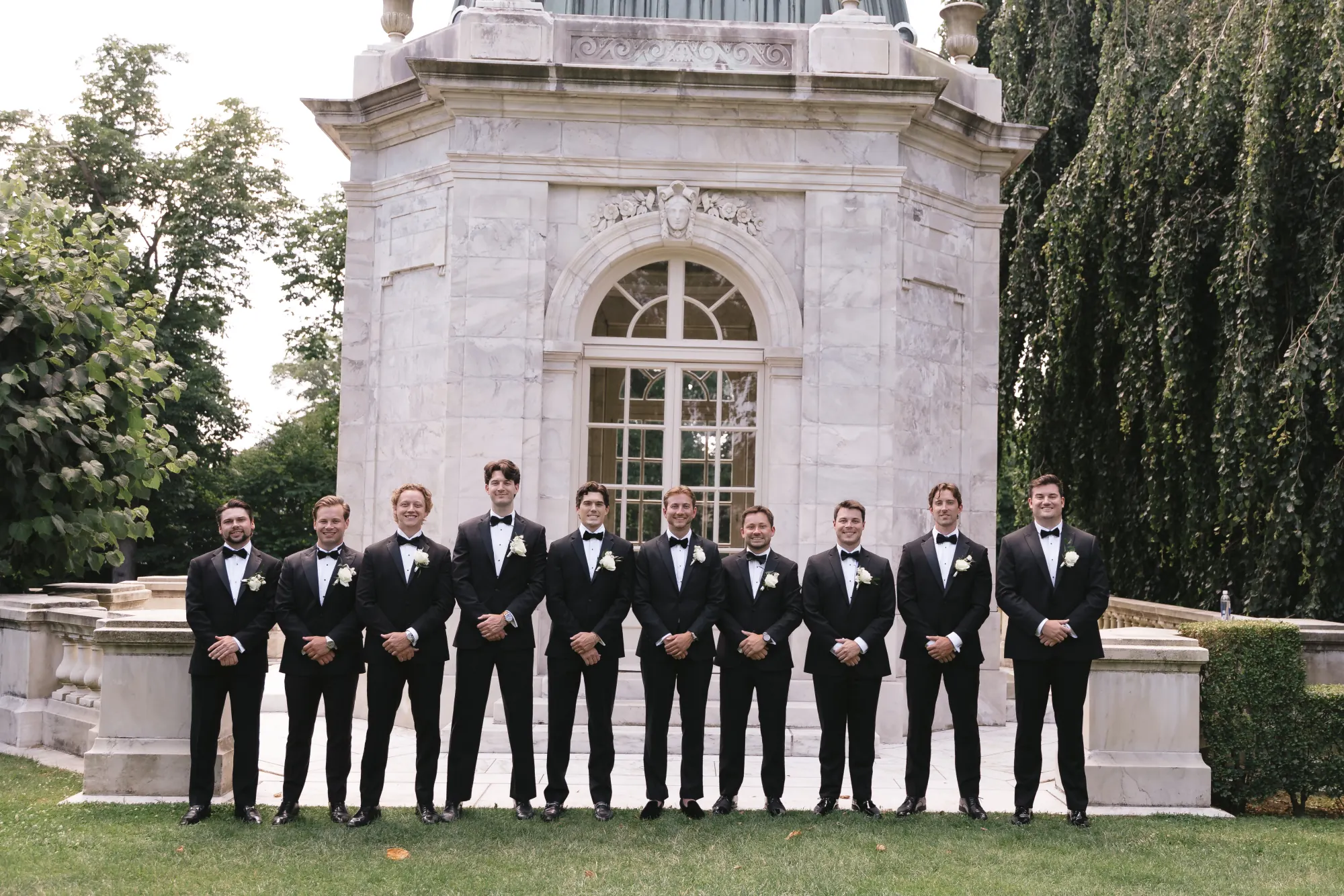 Groom and groomsmen lined up at The Elms garden pavilion