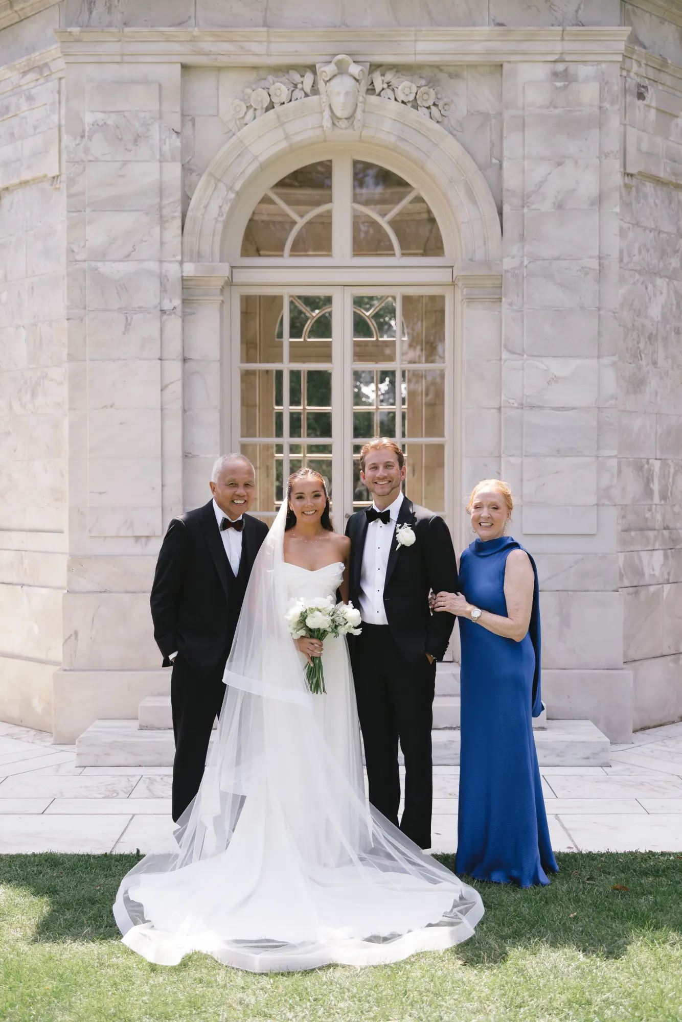 Bride and groom with the bride's parents at The Elms