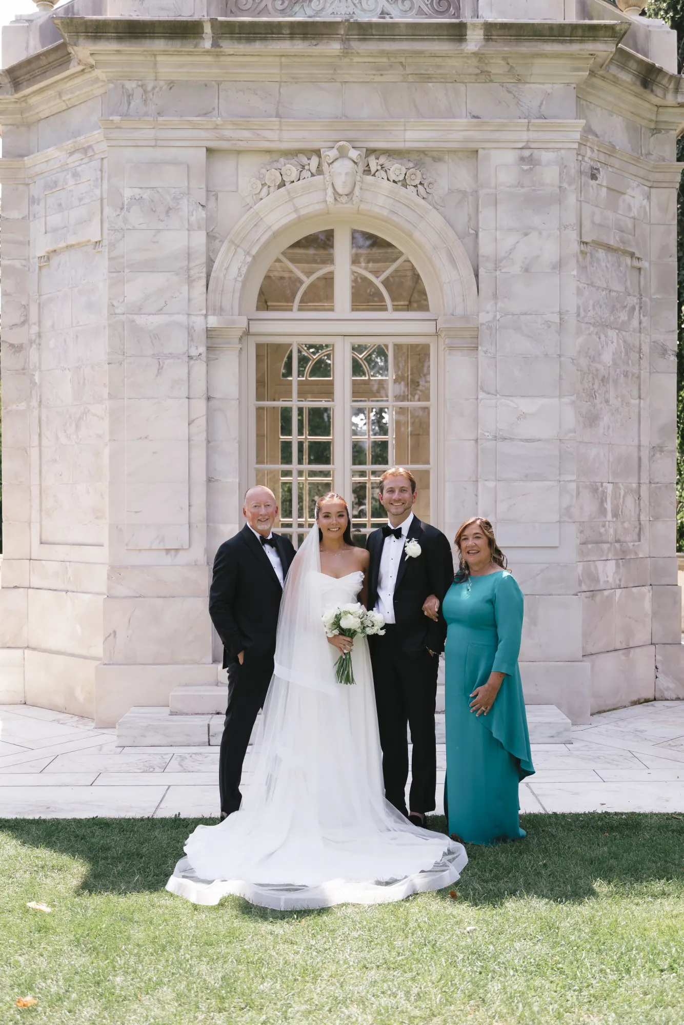 Bride and groom with the groom's parents at The Elms