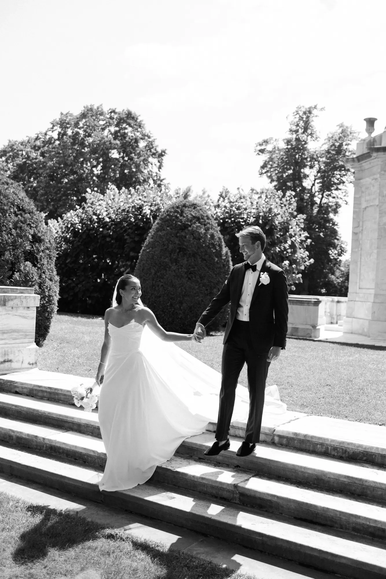 Black and white of the couple on the marble steps at The Elms