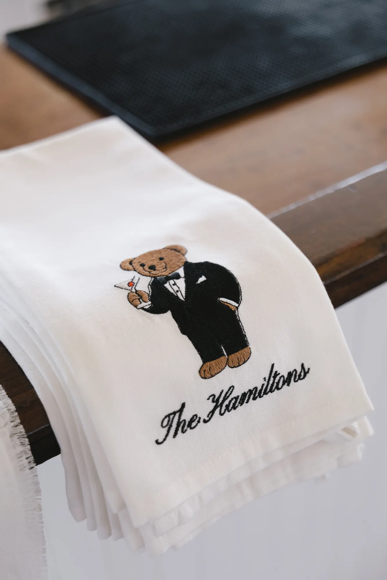 Embroidered Hamiltons cocktail napkins with a tuxedoed bear