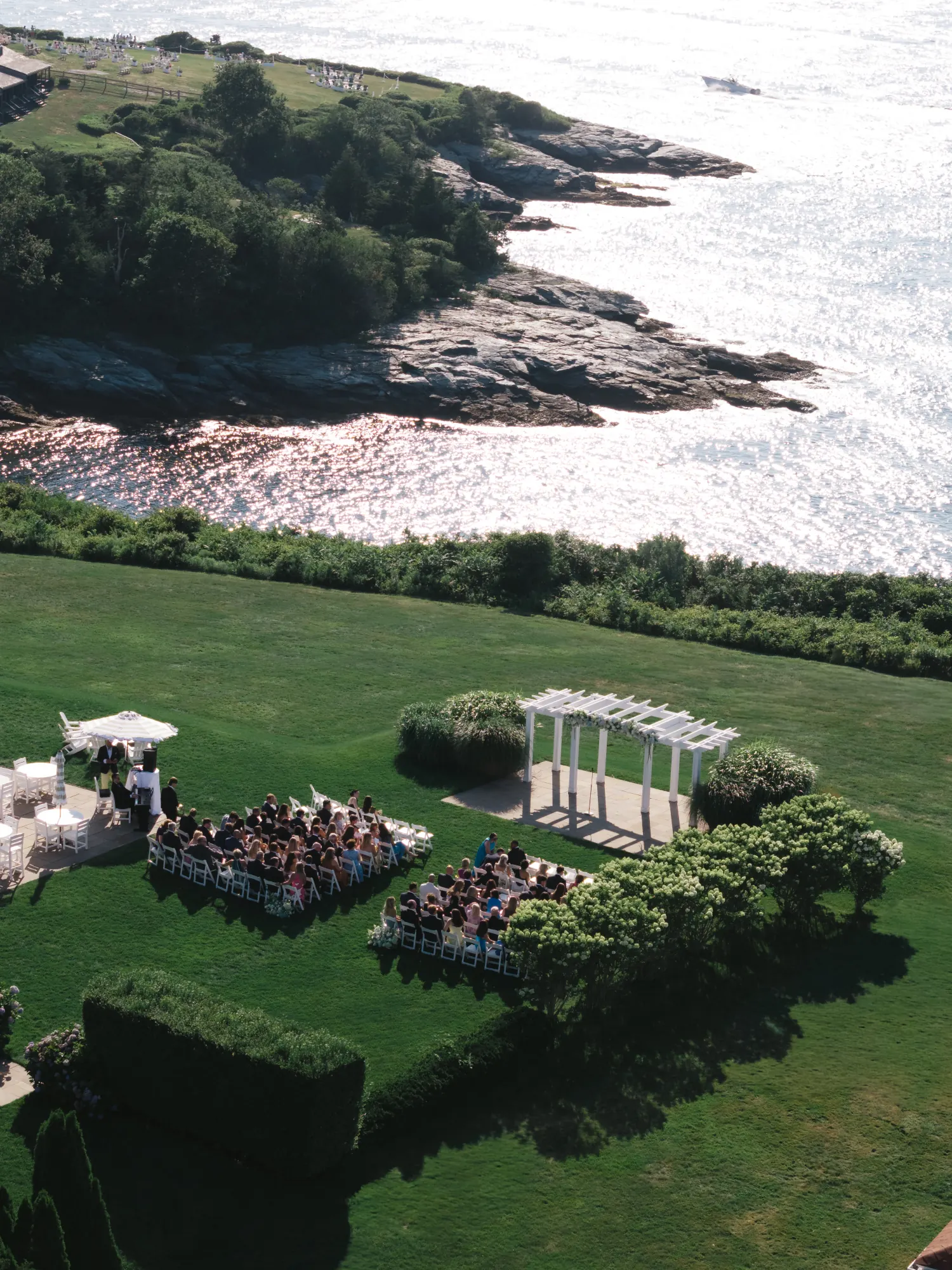 Aerial view of the Bridge Lawn ceremony site along the rocky Newport coastline