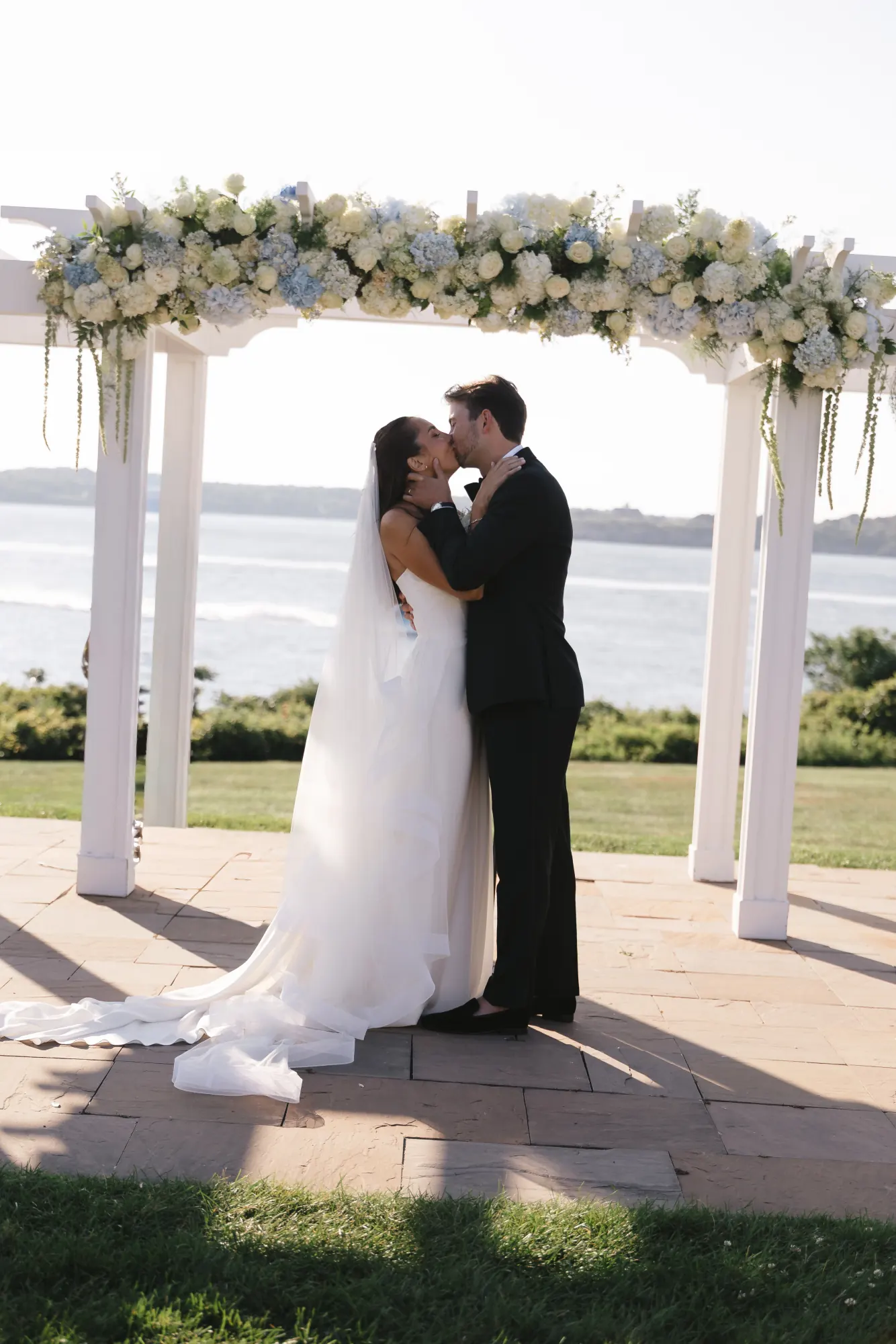 First kiss under the flower-topped pergola at OceanCliff