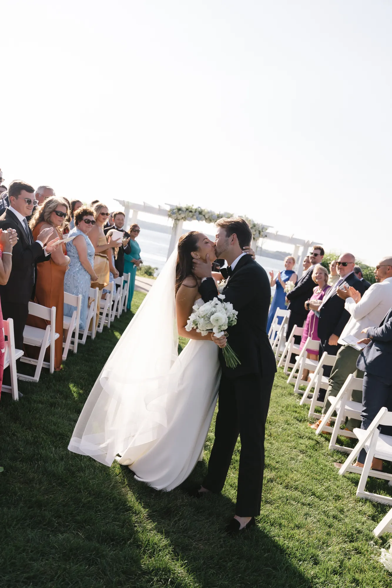 Recessional kiss in the aisle as guests cheer