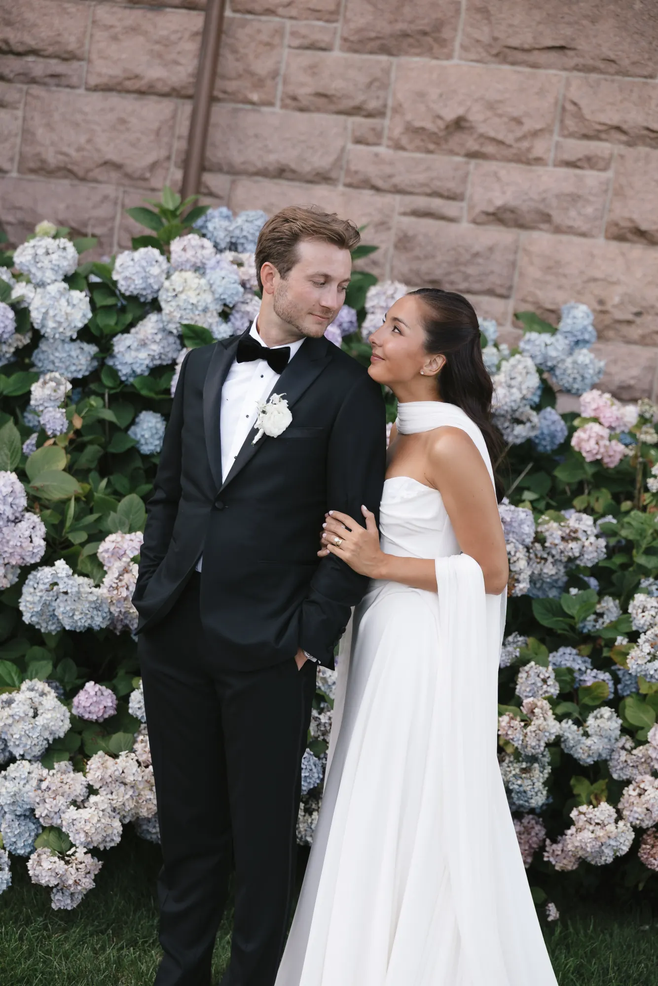 Halle and Zach among the hydrangeas outside OceanCliff
