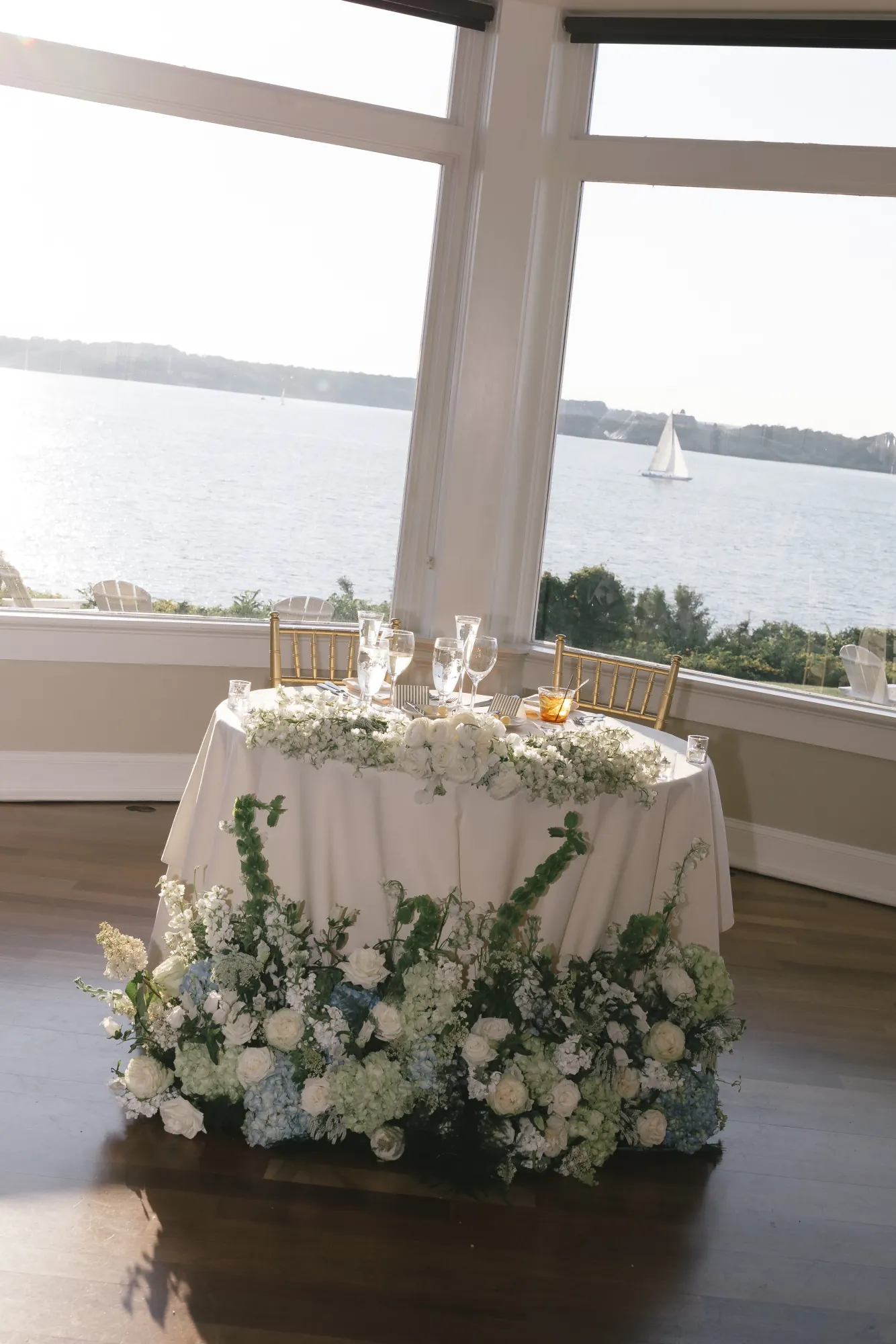 The sweetheart table framed by the ballroom's panoramic windows