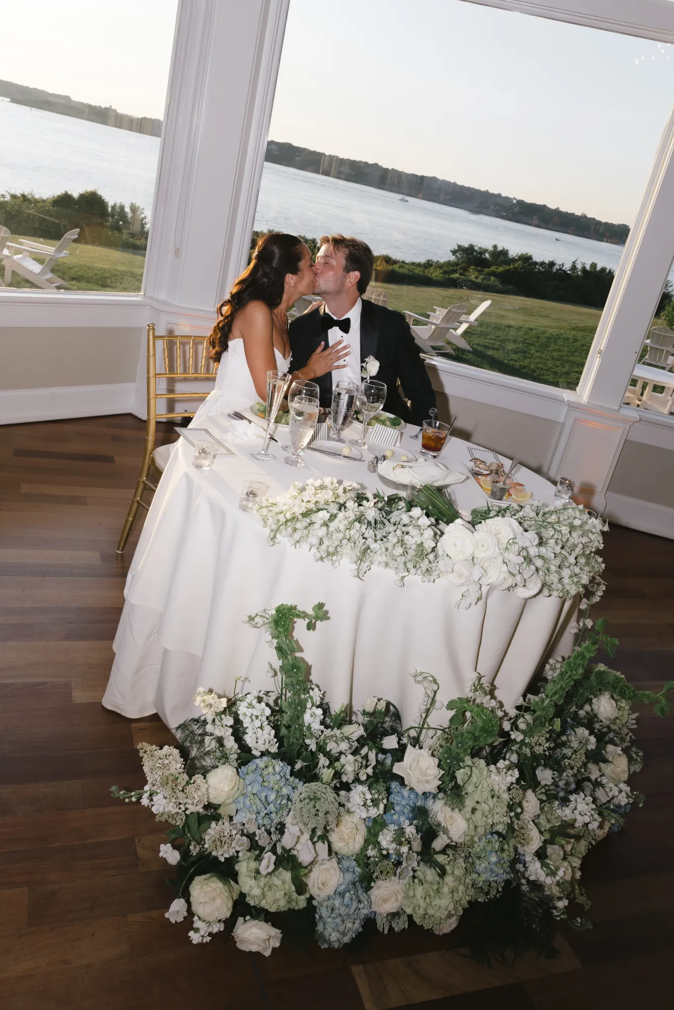 A quiet kiss at the sweetheart table between courses