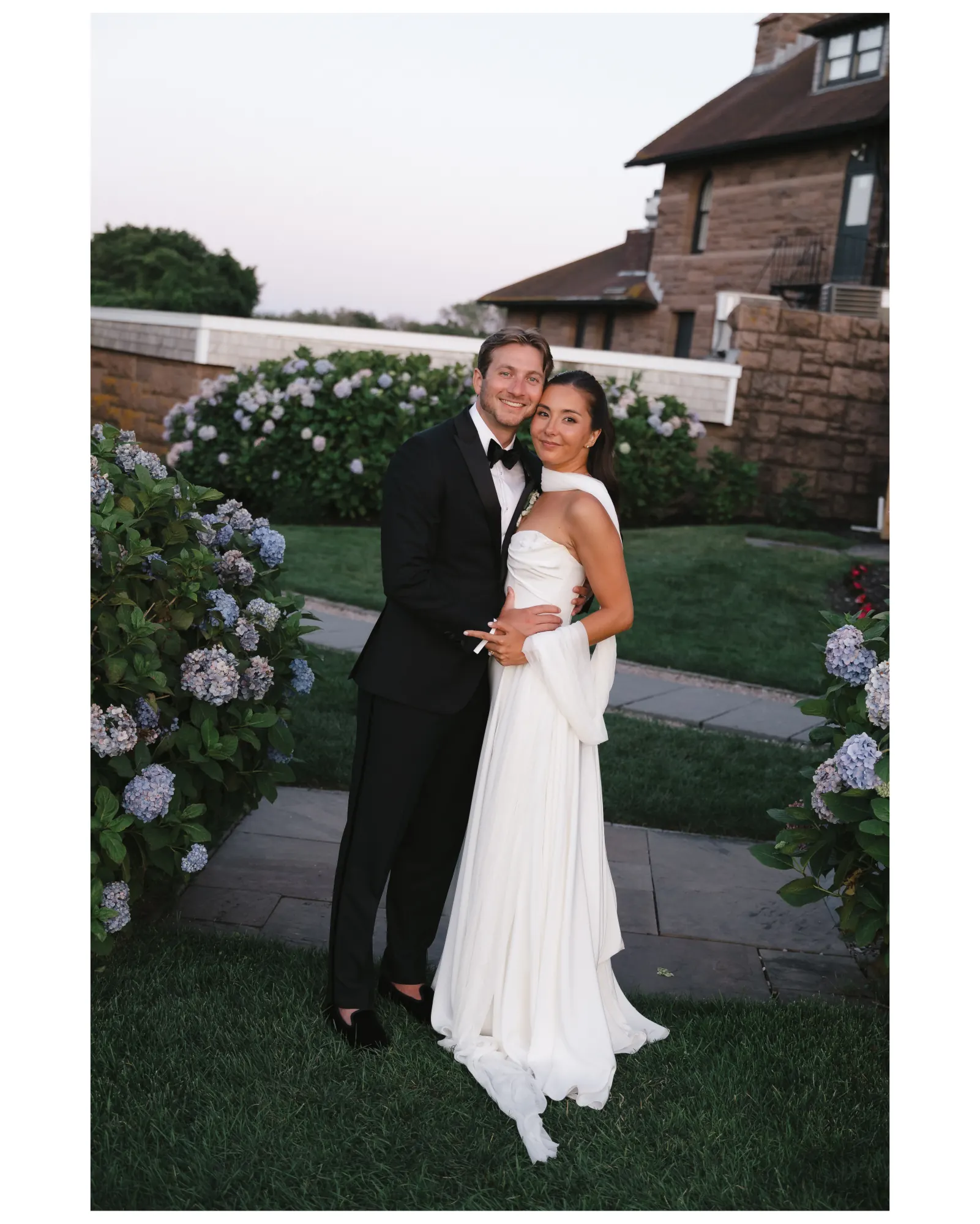 Golden hour portrait beside the hydrangeas and the stone mansion