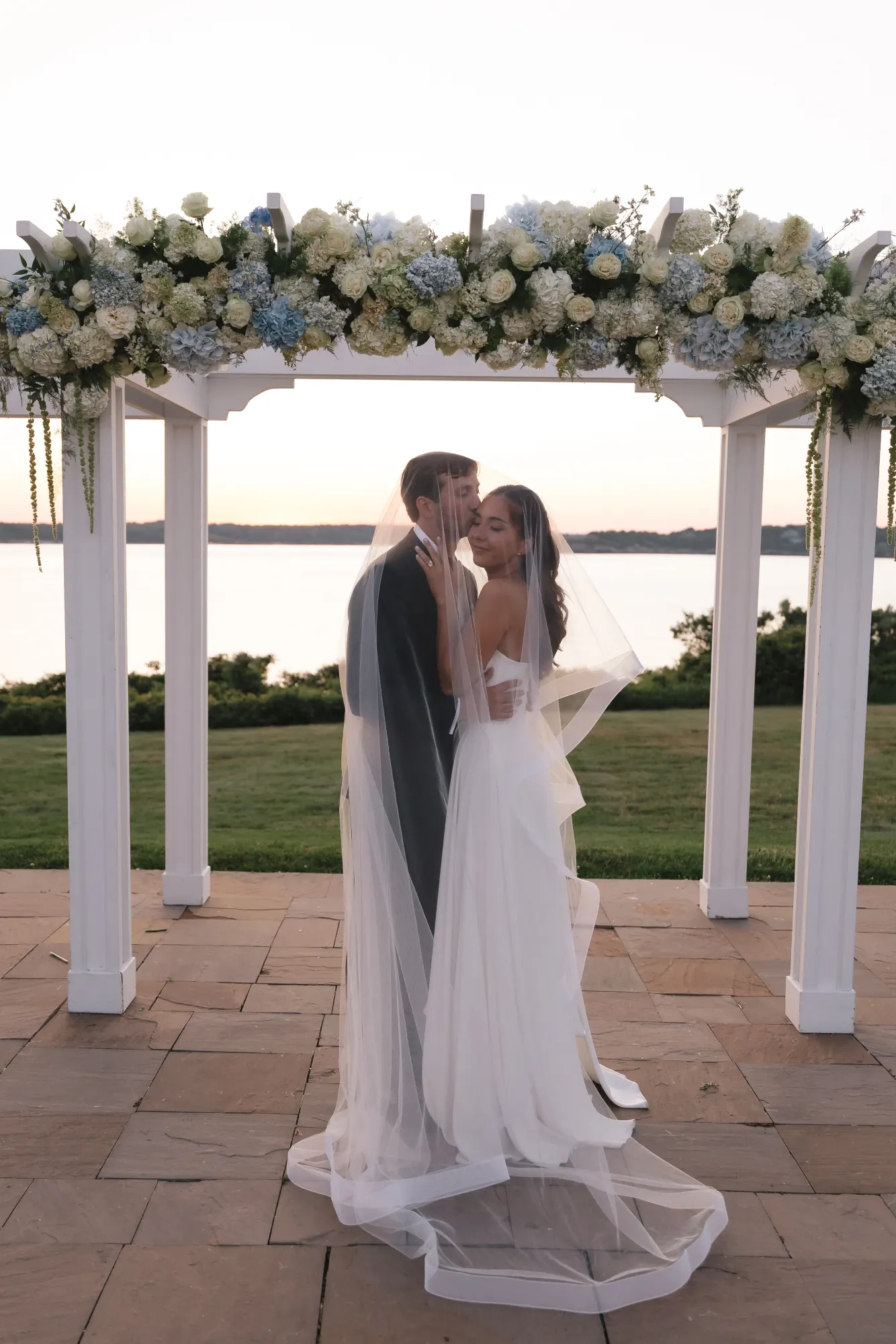 Dusk kiss beneath the floral pergola on the Bridge Lawn