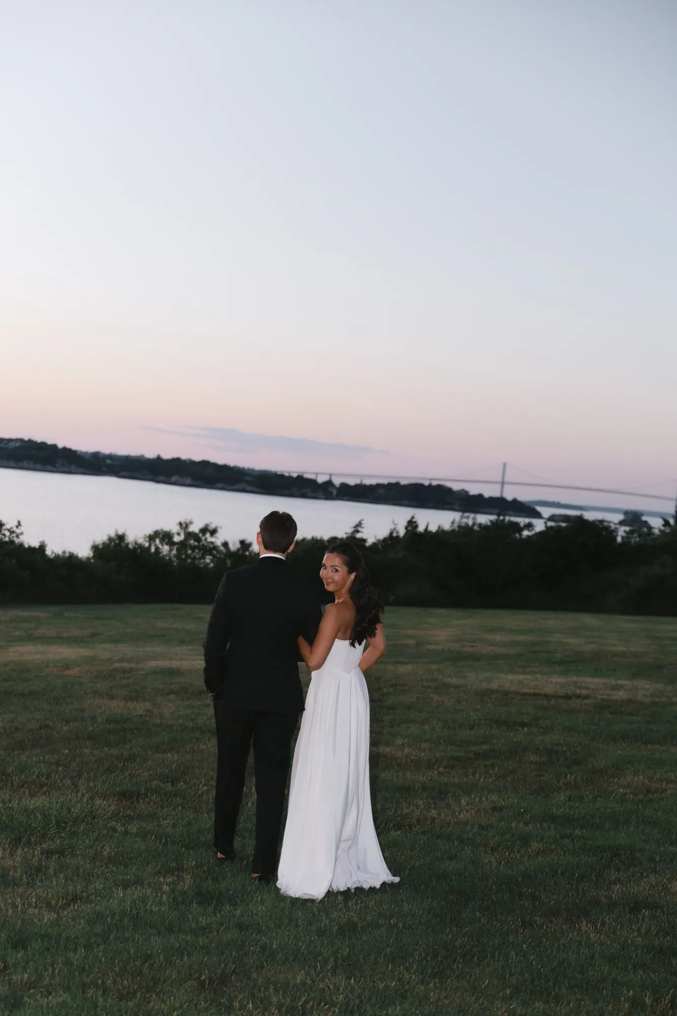 Newlyweds watch the last light fade over Narragansett Bay
