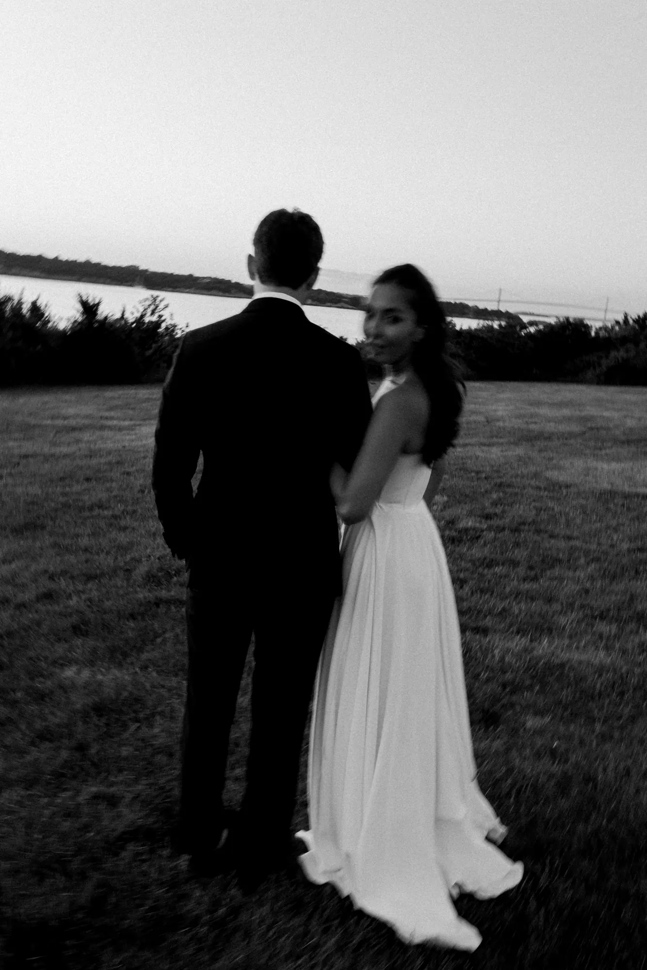 Black and white of the couple at nightfall on the lawn
