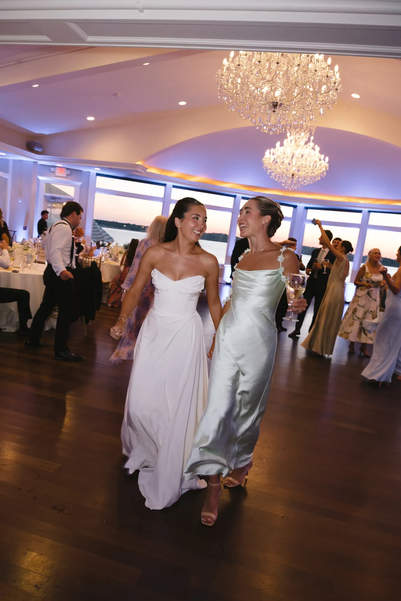 The bride returns to the dance floor beneath the chandelier
