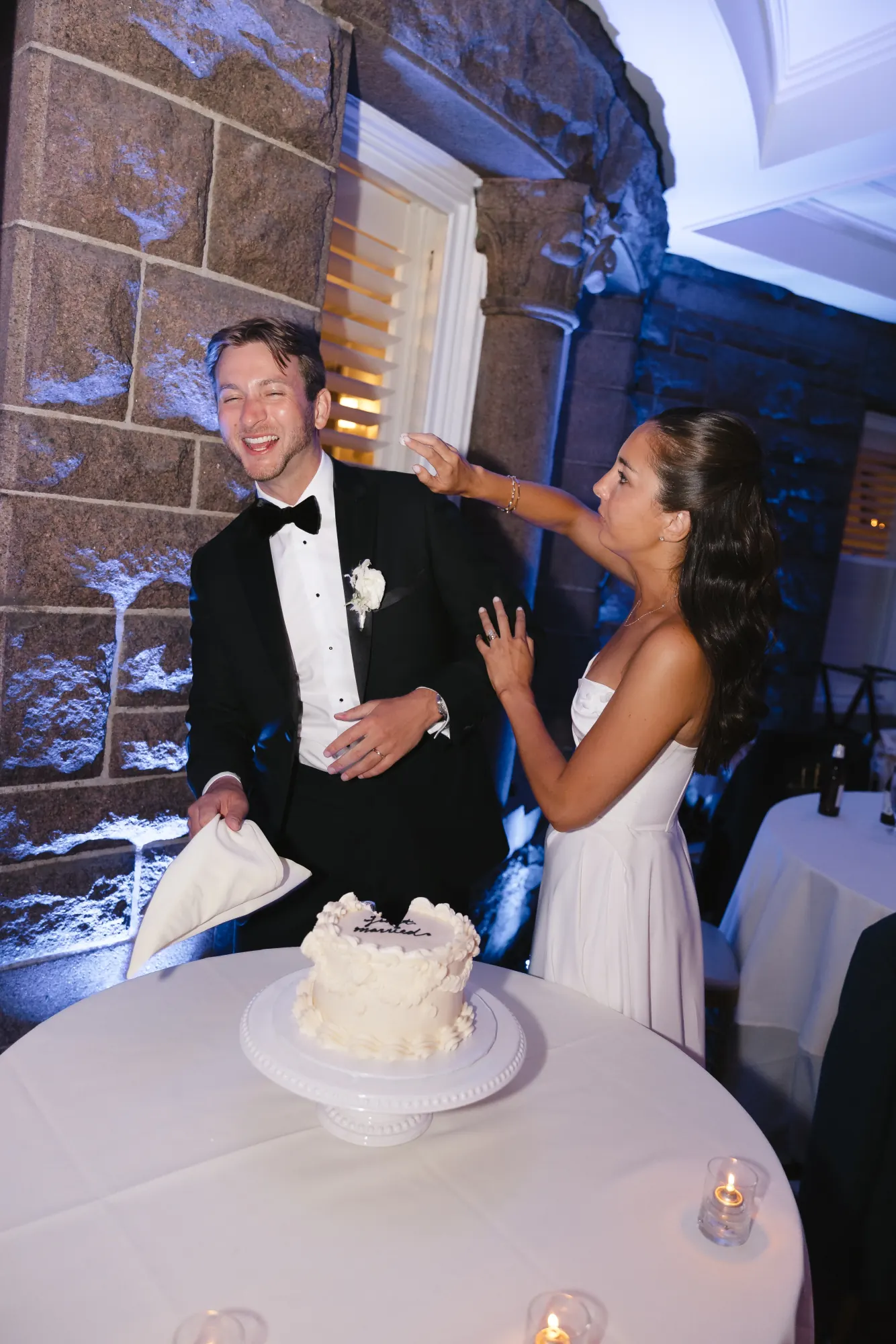 A playful smear of frosting at the cake cutting