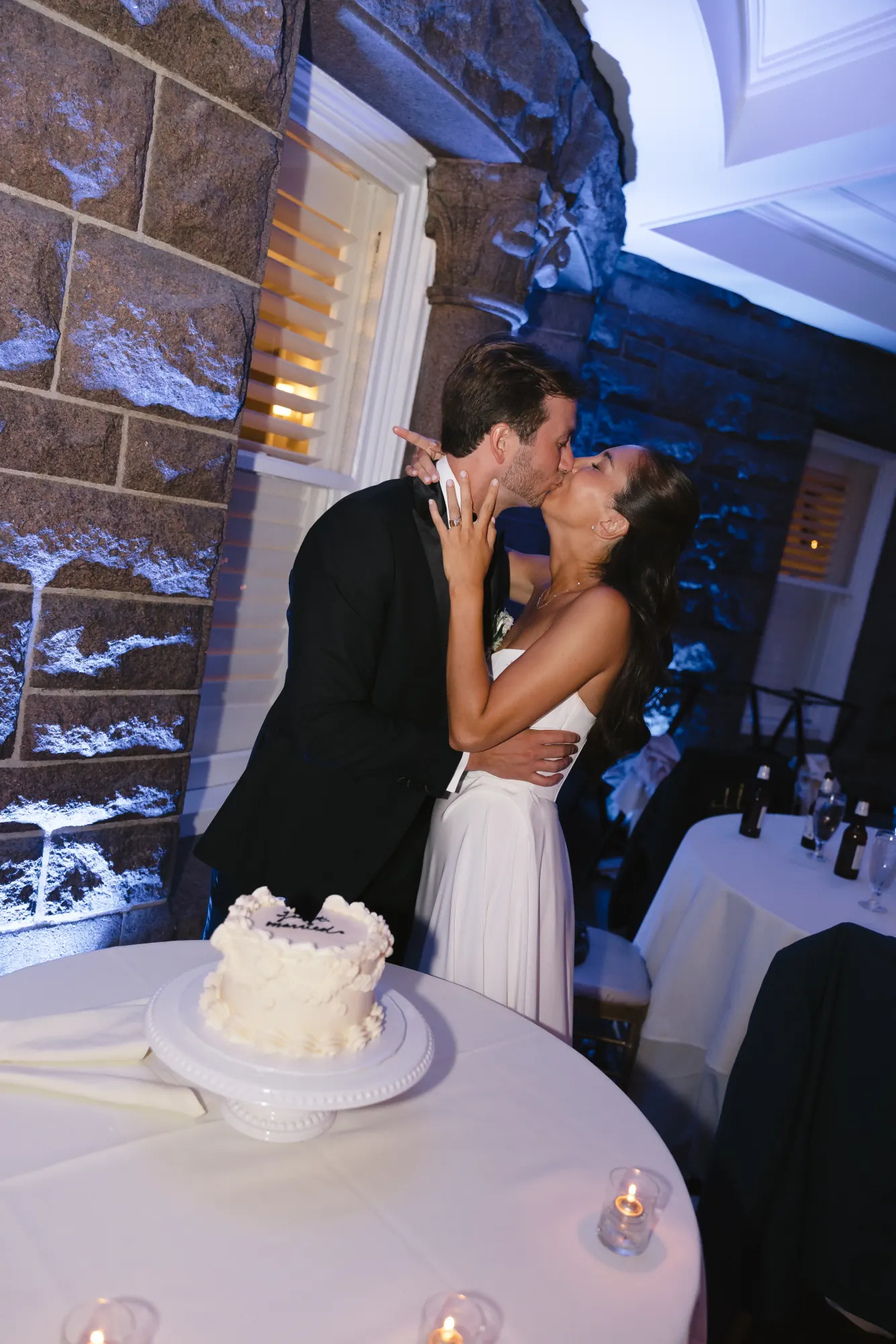 Kiss beside the cake table on the terrace
