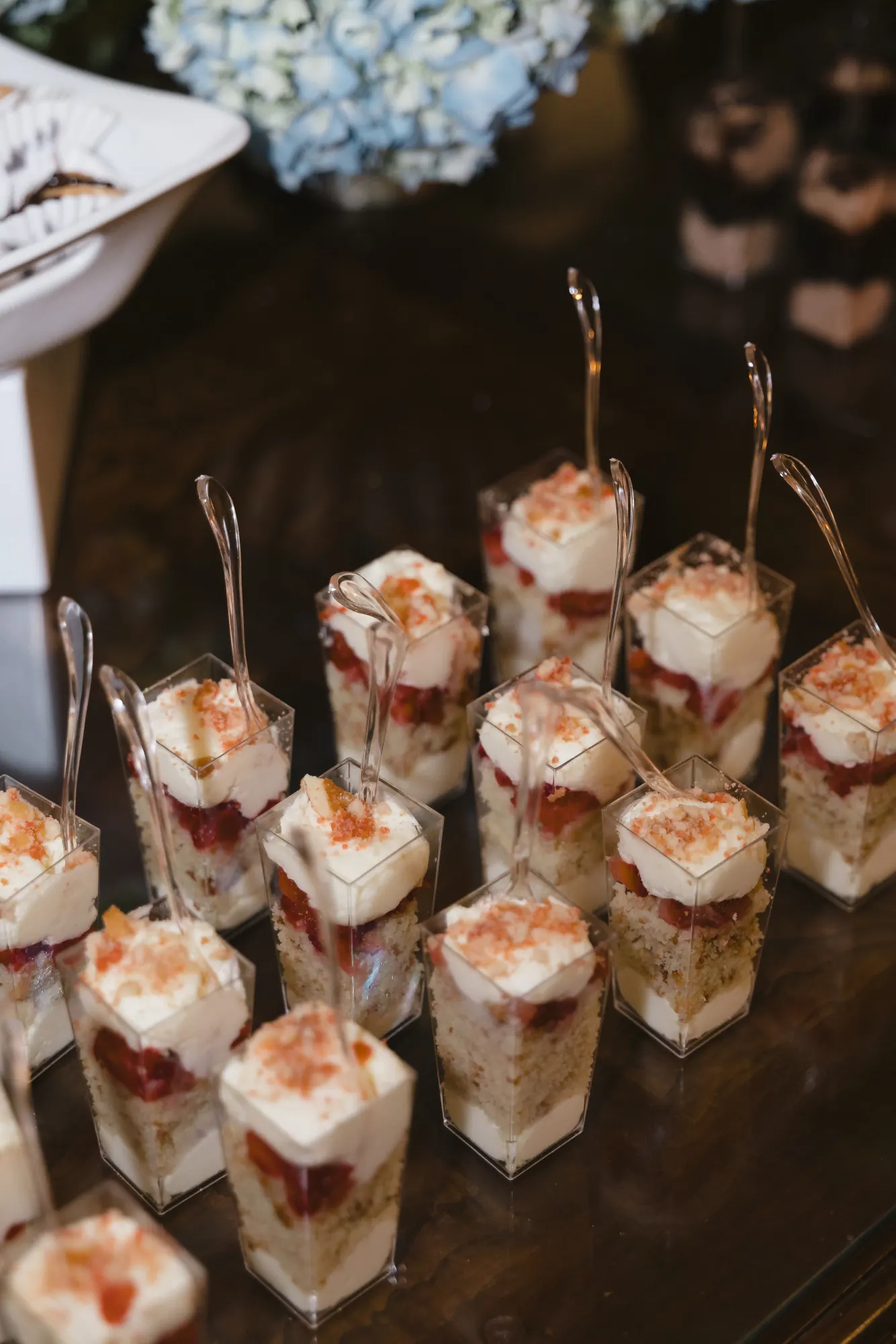 Strawberry shortcake dessert cups lined up for guests