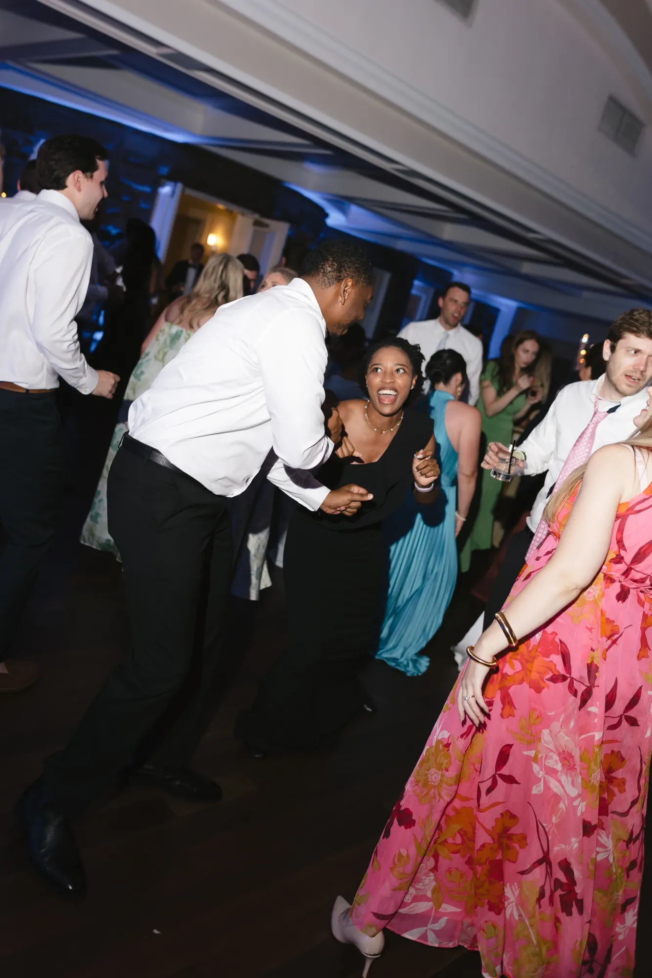 Guests dance in the glow of the ballroom lights