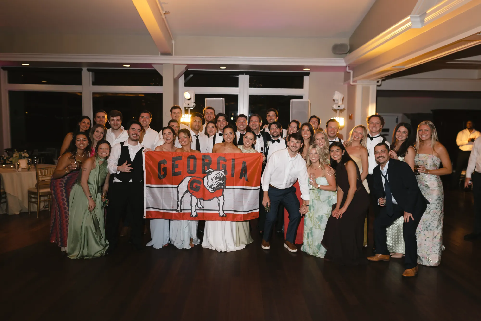 The college flags come out for a group photo on the dance floor