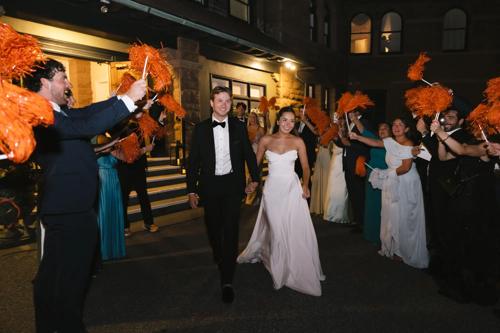Guests line the walk waving ribbon wands for the grand exit