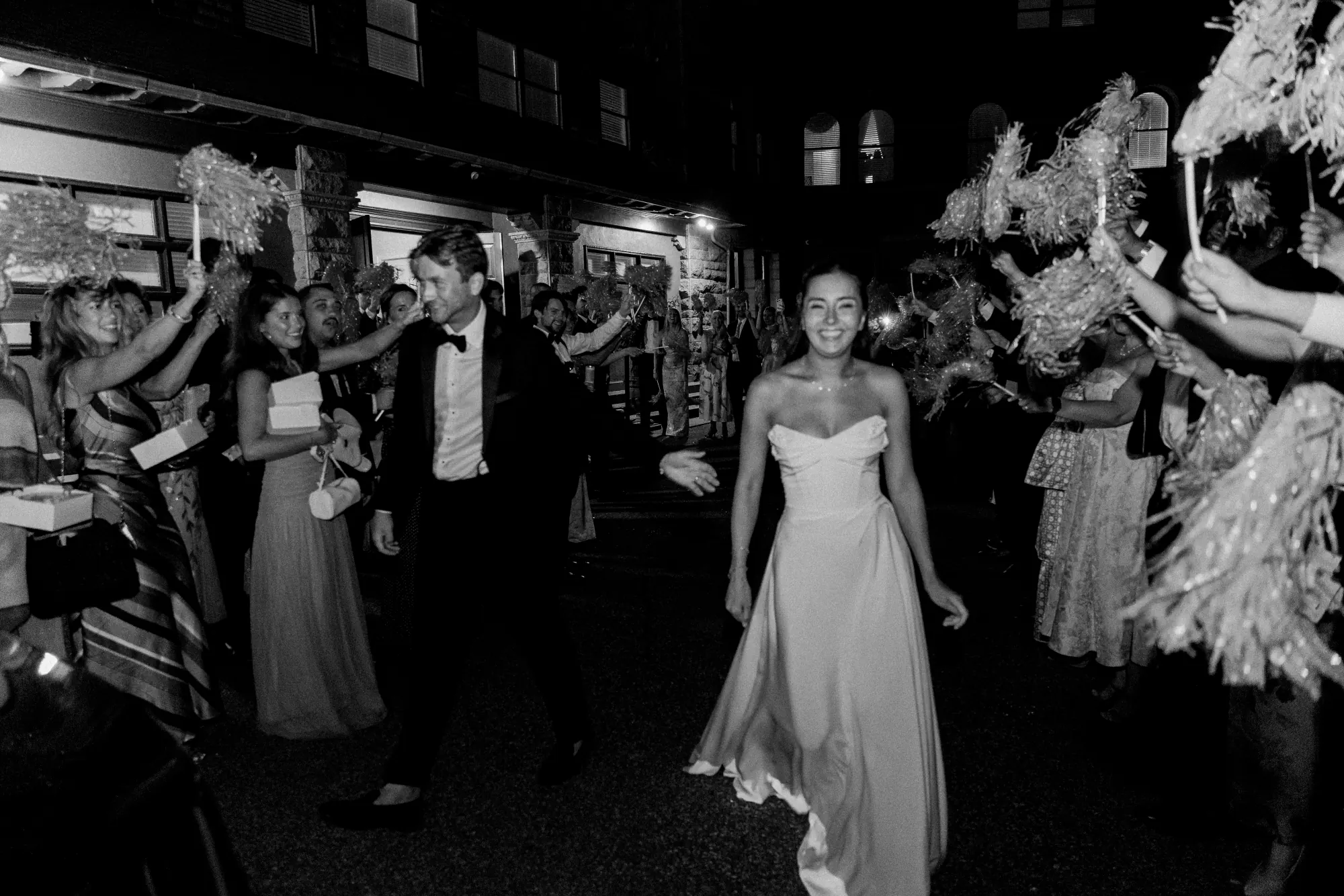 Black and white of the newlyweds' ribbon-wand sendoff at OceanCliff