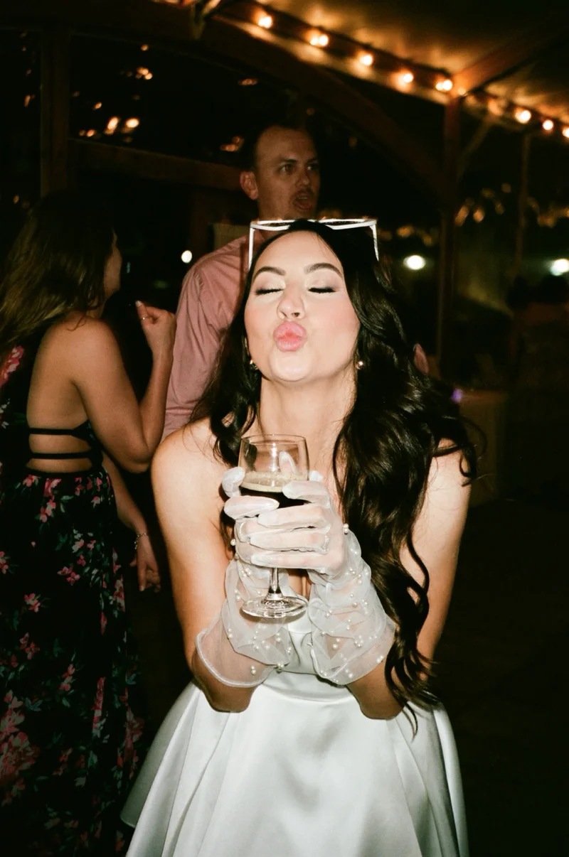 Bride with champagne at reception